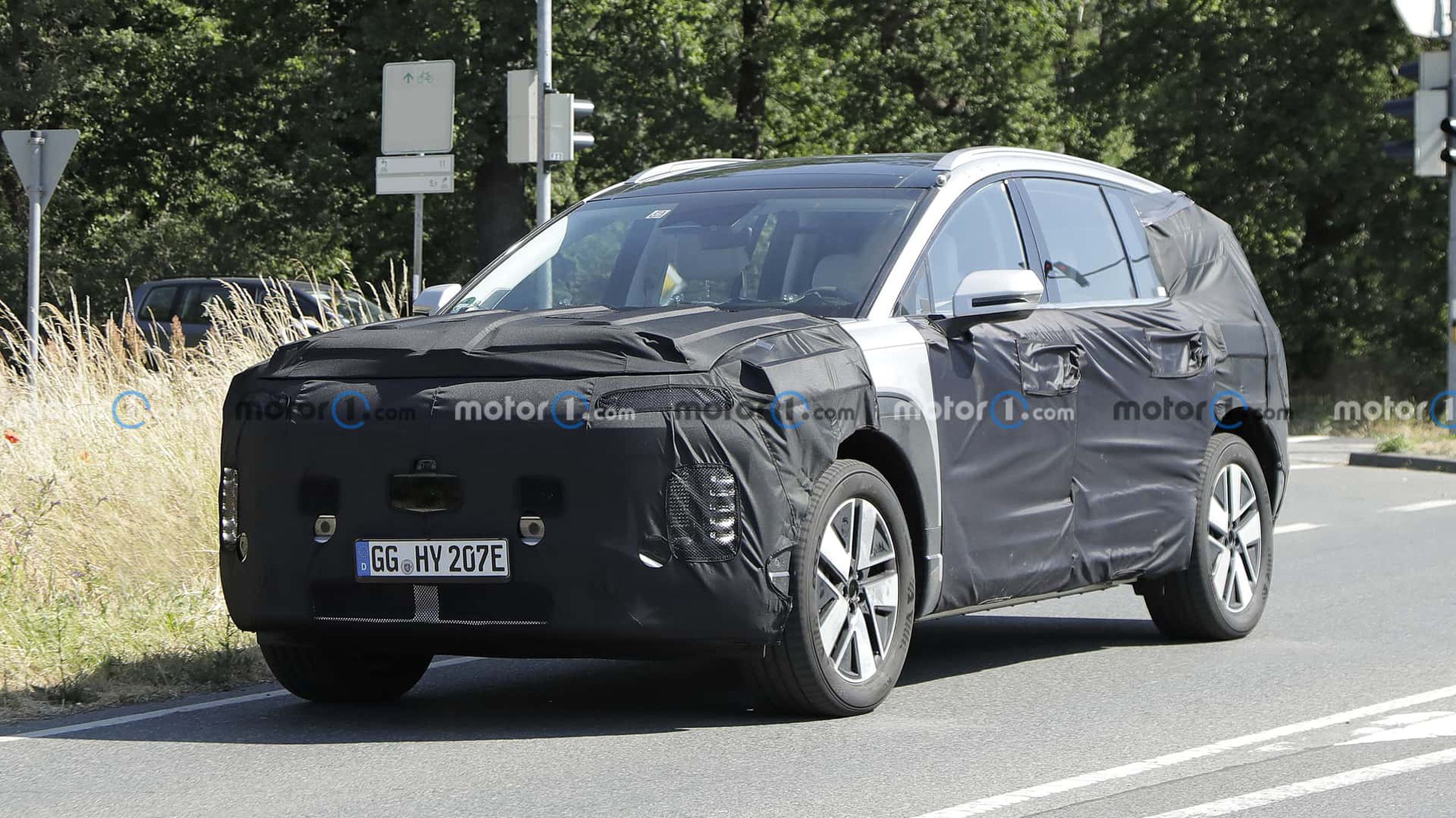 A camouflaged large Hyundai vehicle that might be an Ioniq 7.