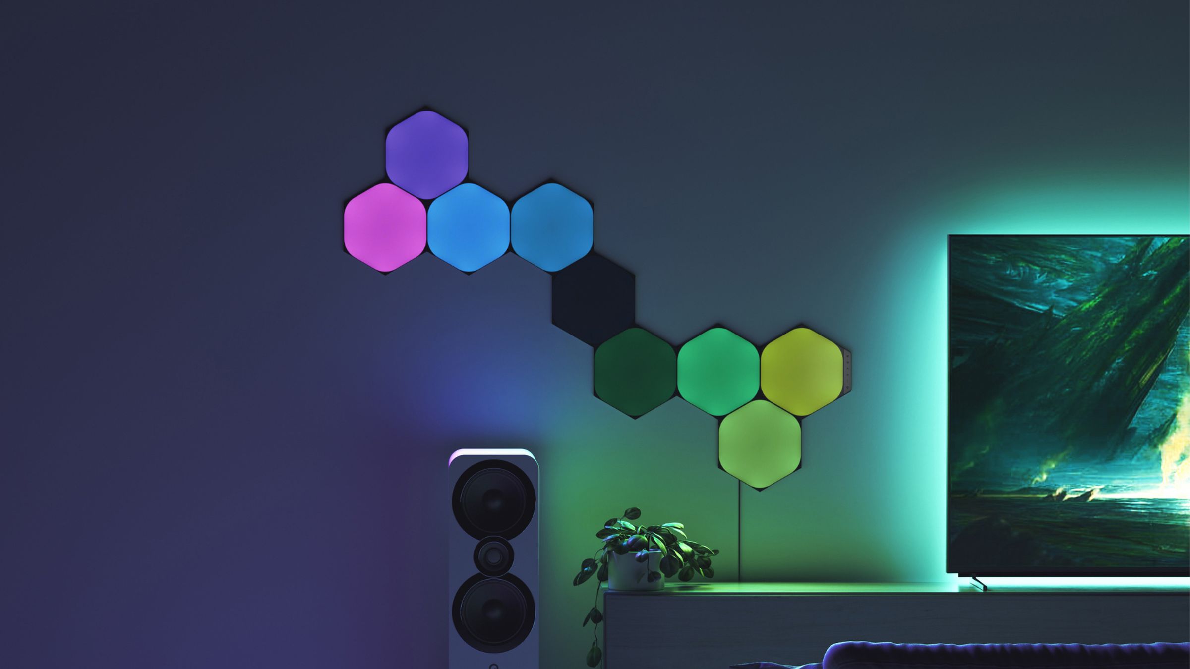 The Nanoleaf Shapes Ultra Black Hexagons beside a TV.