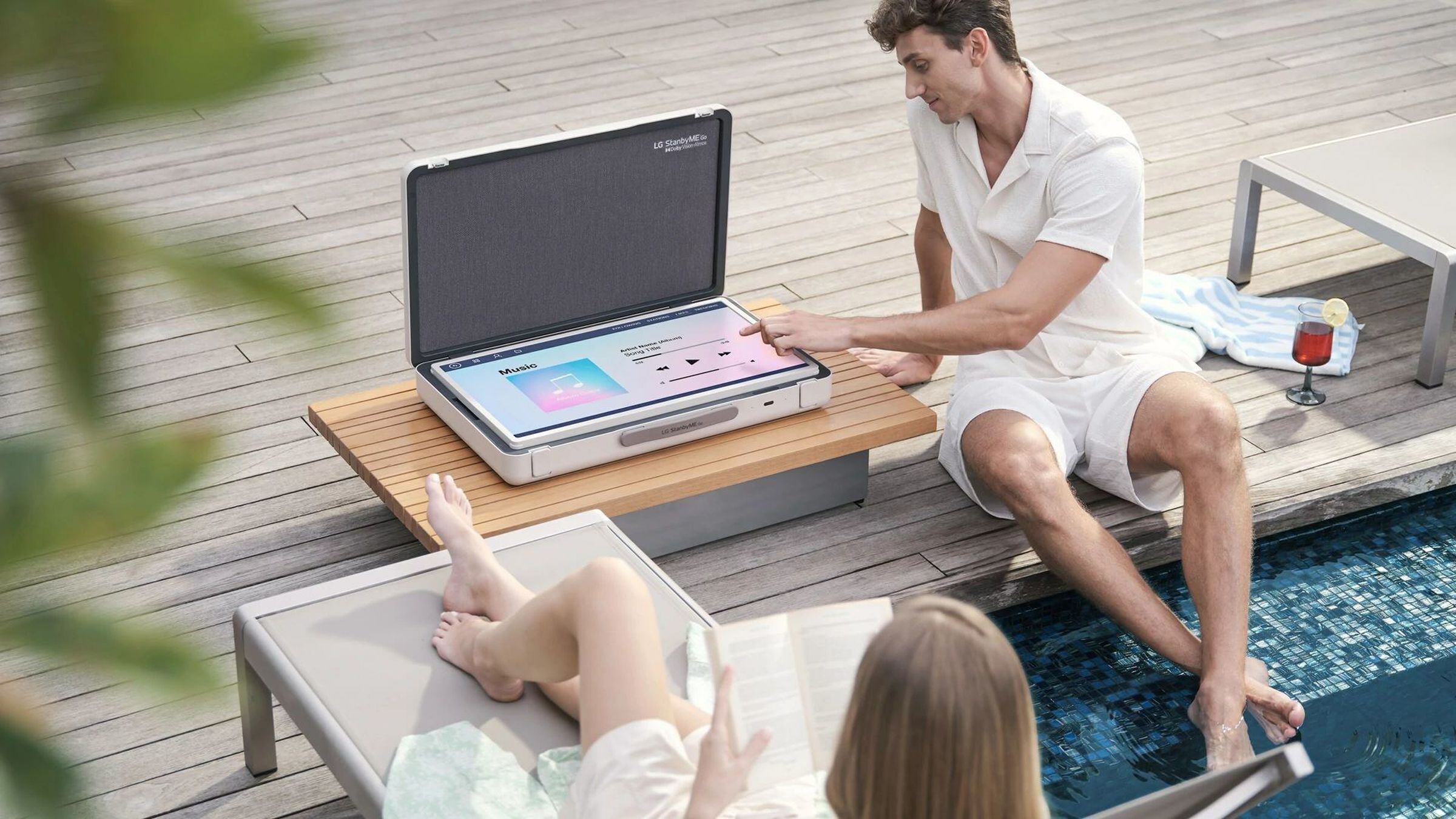 A photo of LG’s StanbyMe Go on a back porch near a pool.