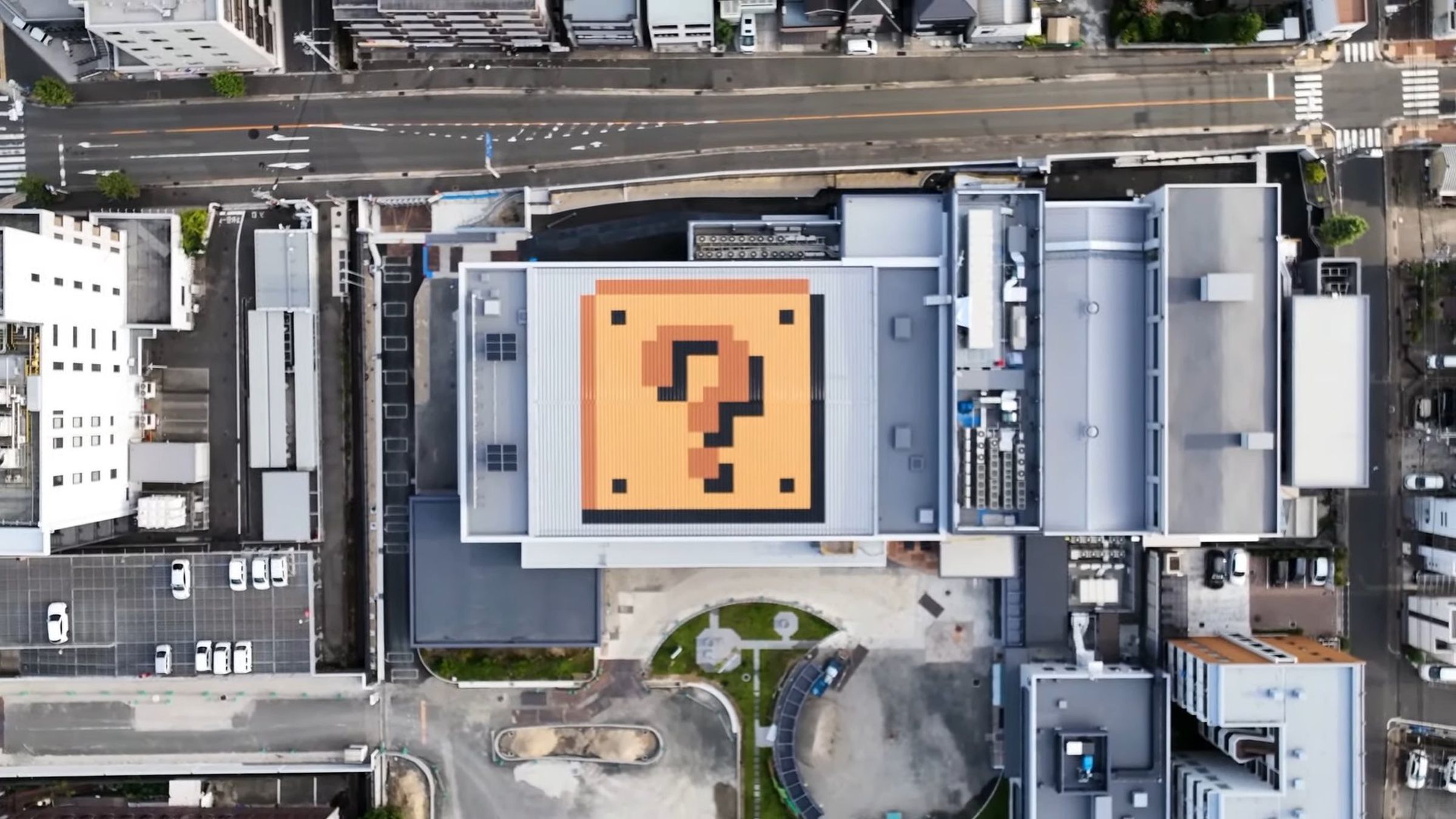 Aerial picture of the Nintendo Museum construction site, showing a building with one of the “question” blocks from Mario on the roof.