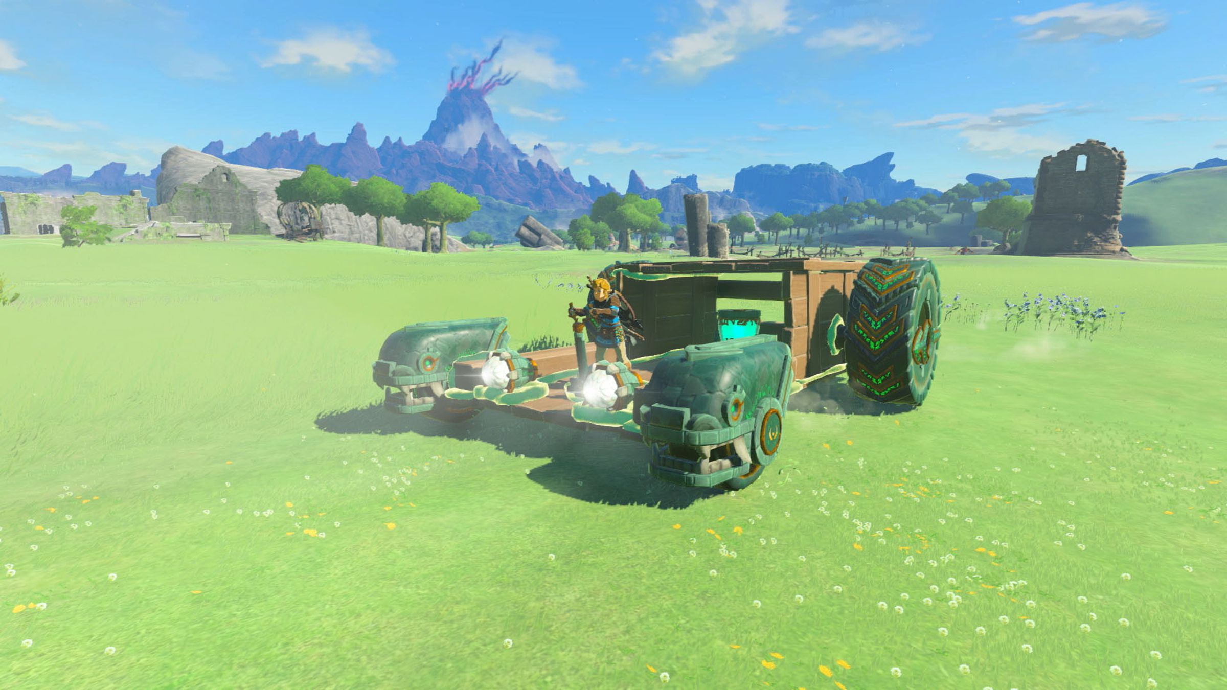 Screenshot from Tears of the Kingdom featuring Link driving a handmade vehicle out of wood and wheels.