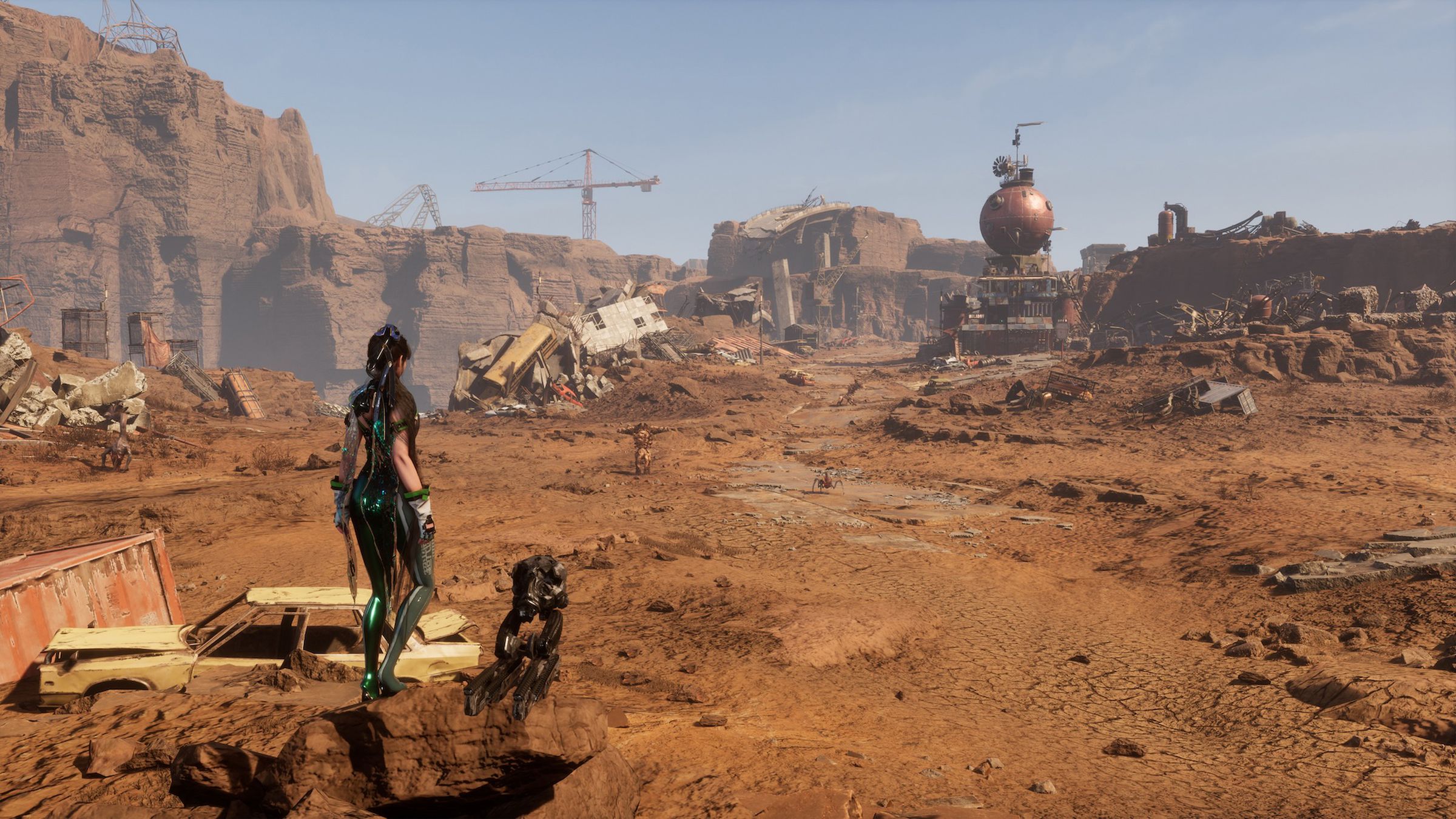 Screenshot from Stellar Blade featuring Eve surveying a vast desert littered with abandoned machinery and ruined infrastructure