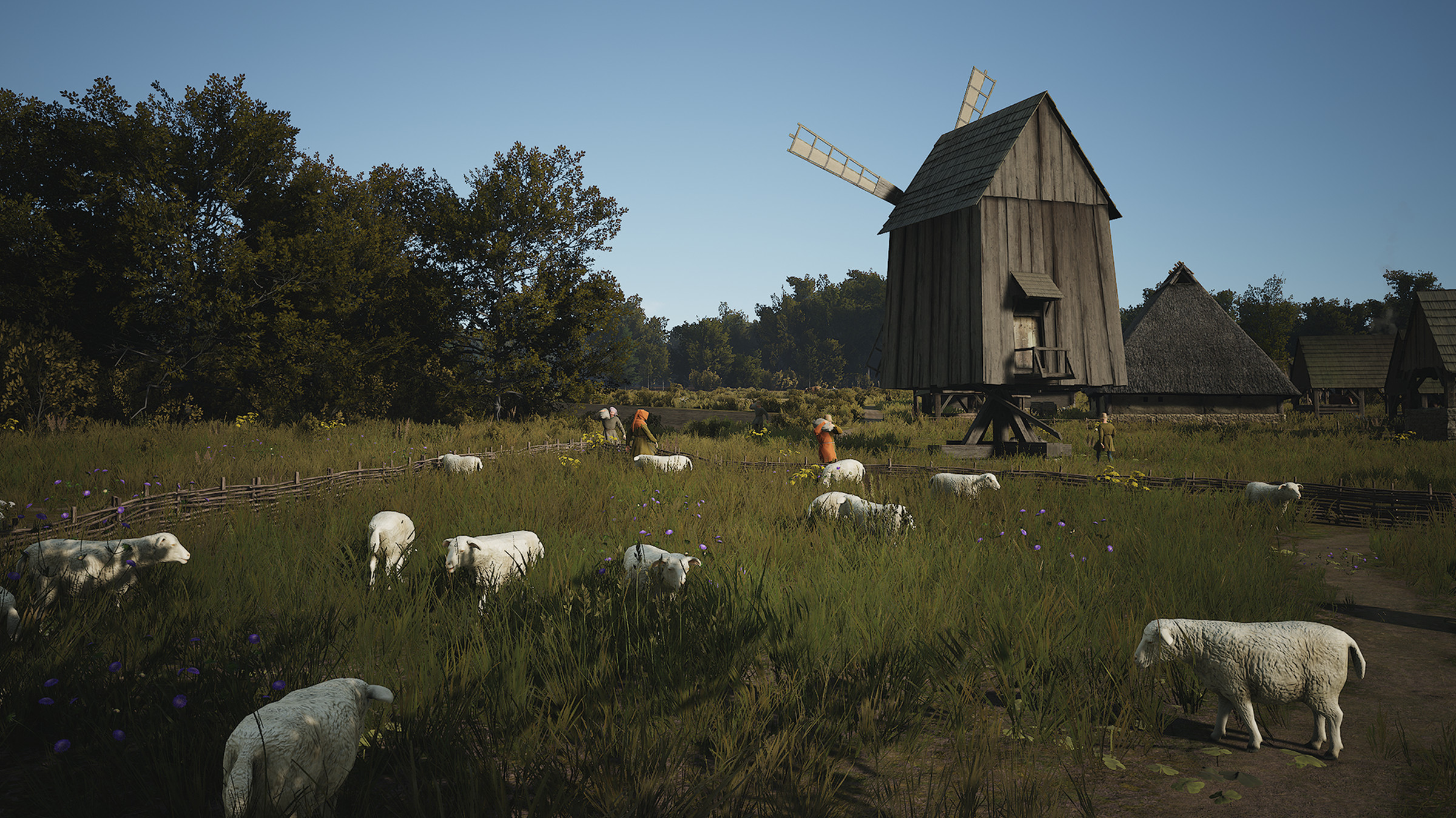 Screenshot from Manor Lords featuring a sheep pasture with a windmill in the distance.