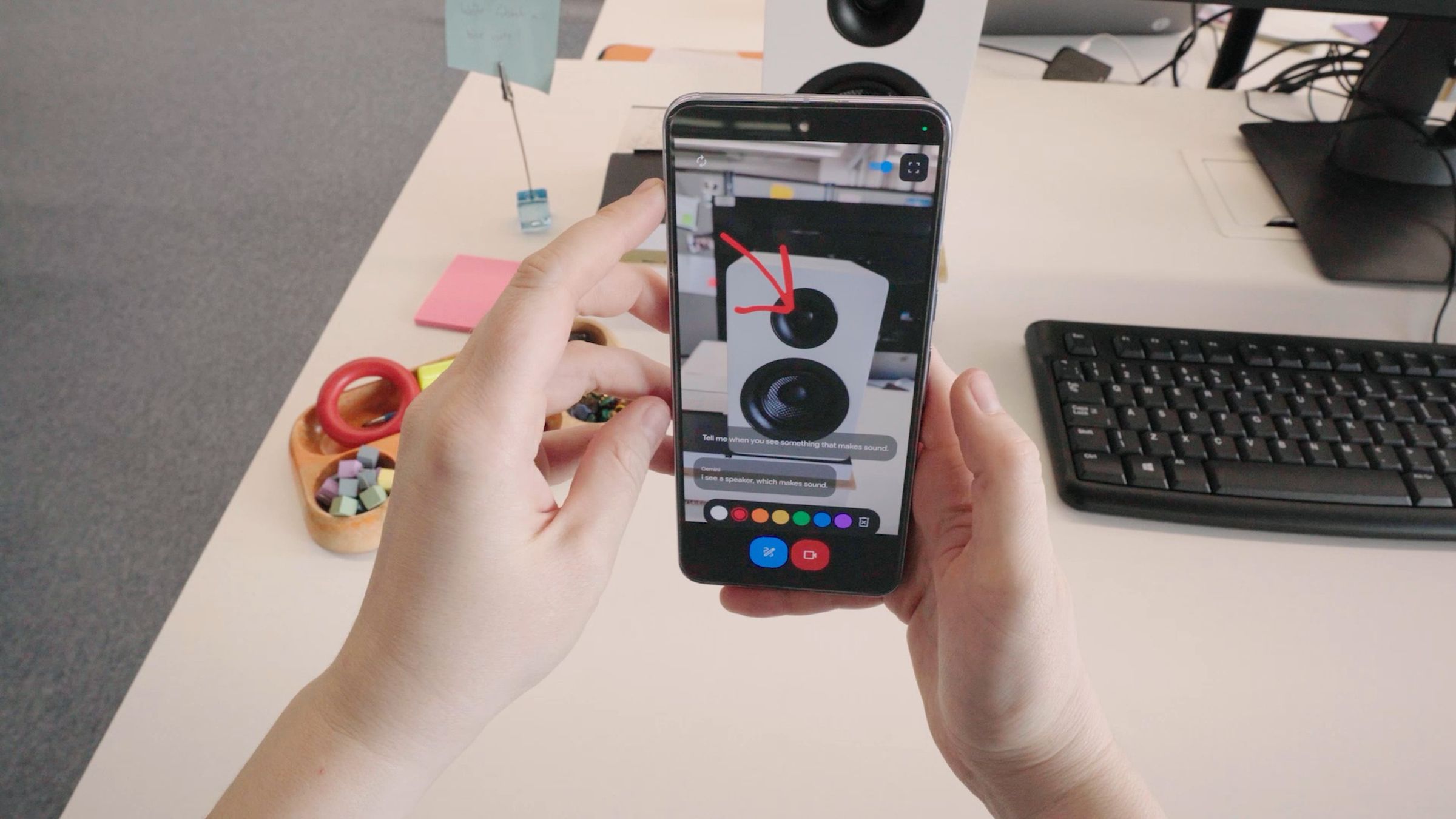 A still from a video showing a phone identifying a speaker tweeter with AI.