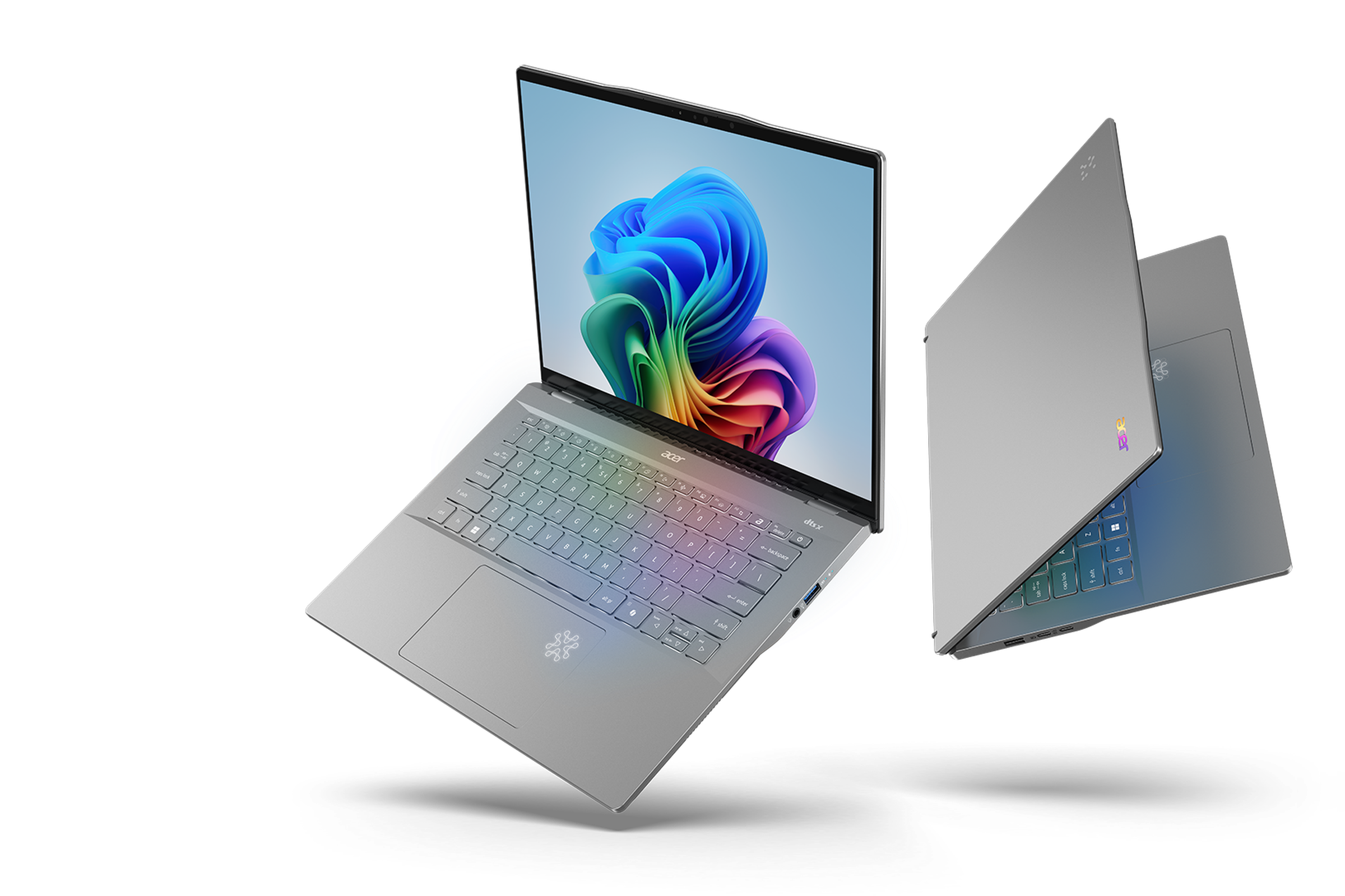 Two silver laptops floating side by side, one open and the other partially closed.
