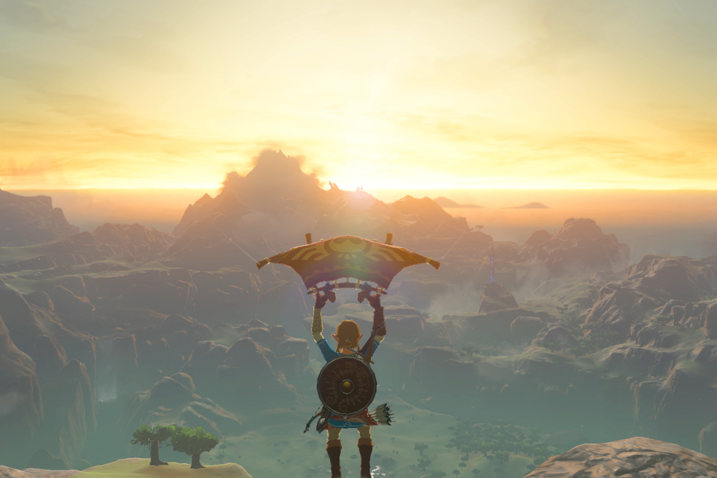 A screenshot from The Legend of Zelda: Breath of the Wild showing Link paragliding toward a golden-colored sunset.