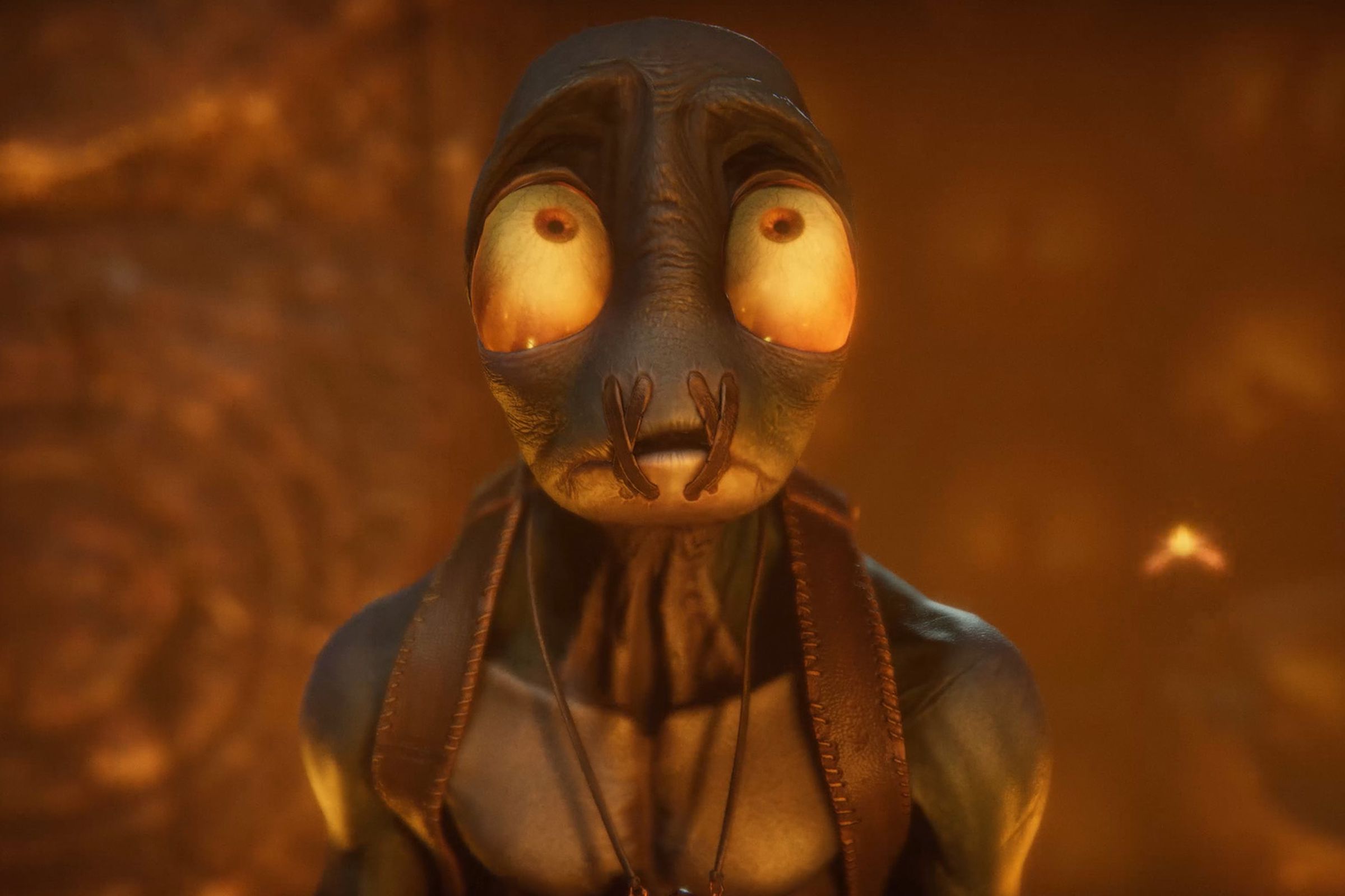 Screenshot from Oddworld Soulstorm in which a blue, hairless alien creature with huge yellow eyes stares at something above him in horrified awe.