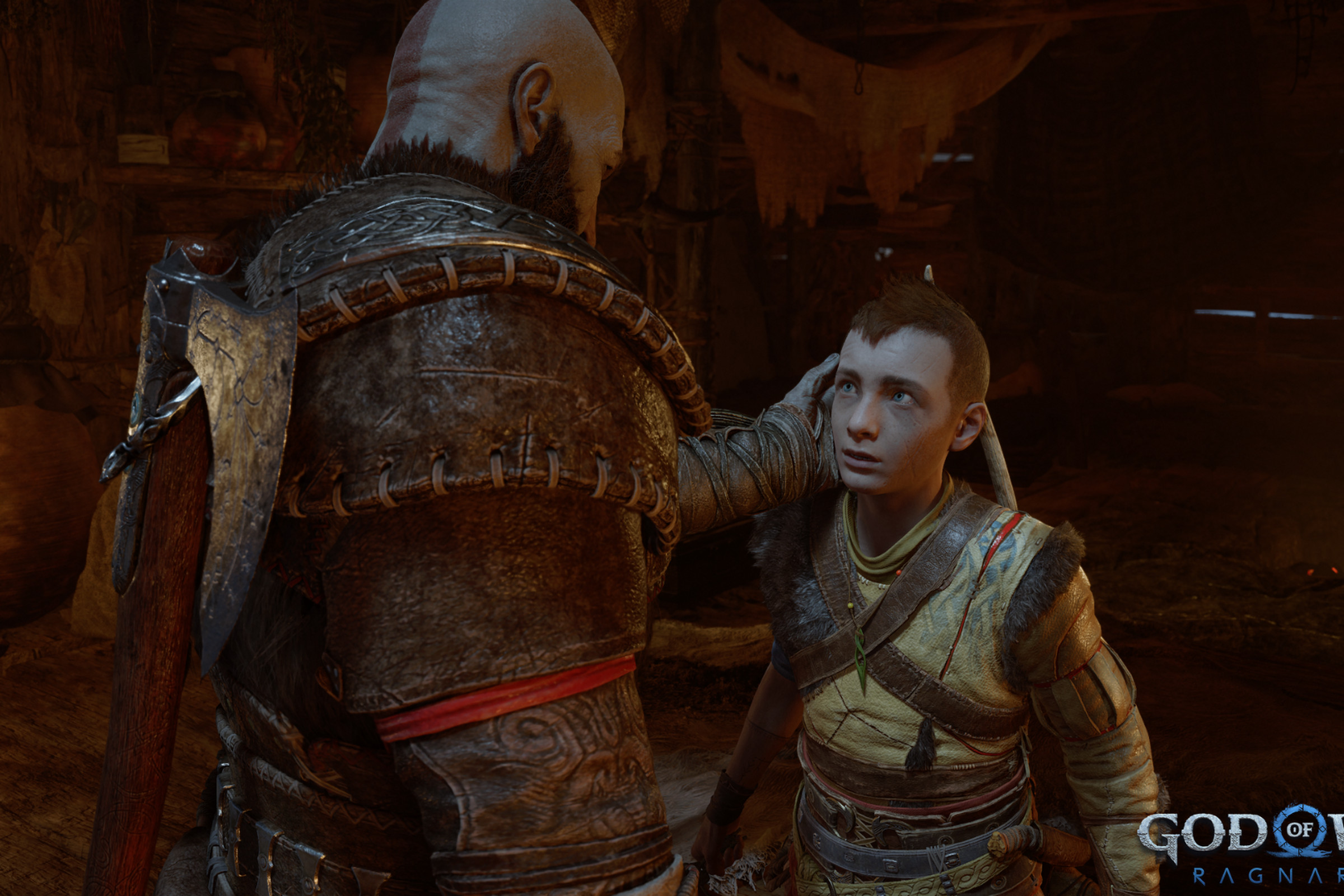 Screenshot from God of War Ragnarök featuring Kratos gently touching the face of his teenage son, Atreus