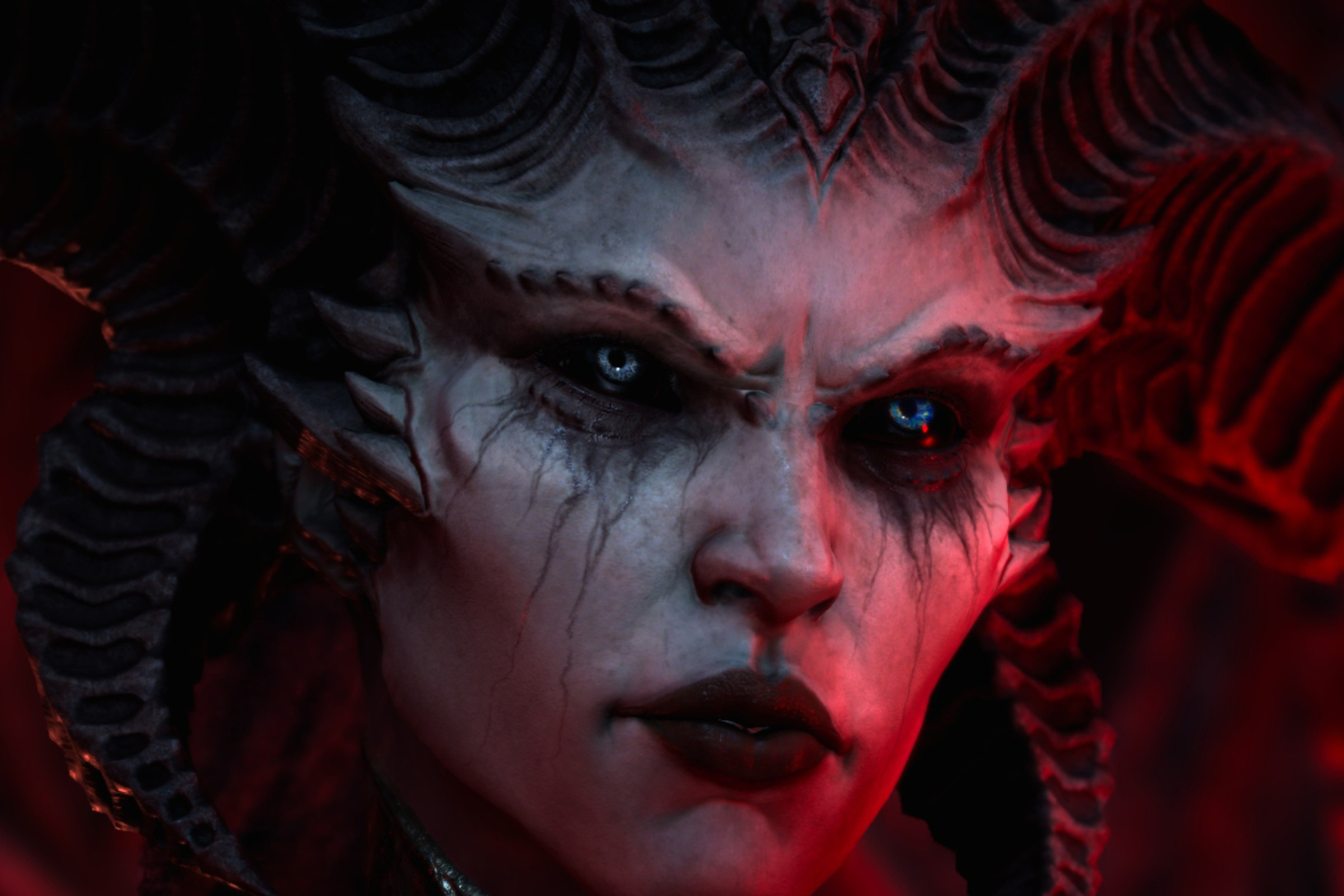 Screenshot from Diablo IV featuring a close-up on the face of the demonic monster Lilith