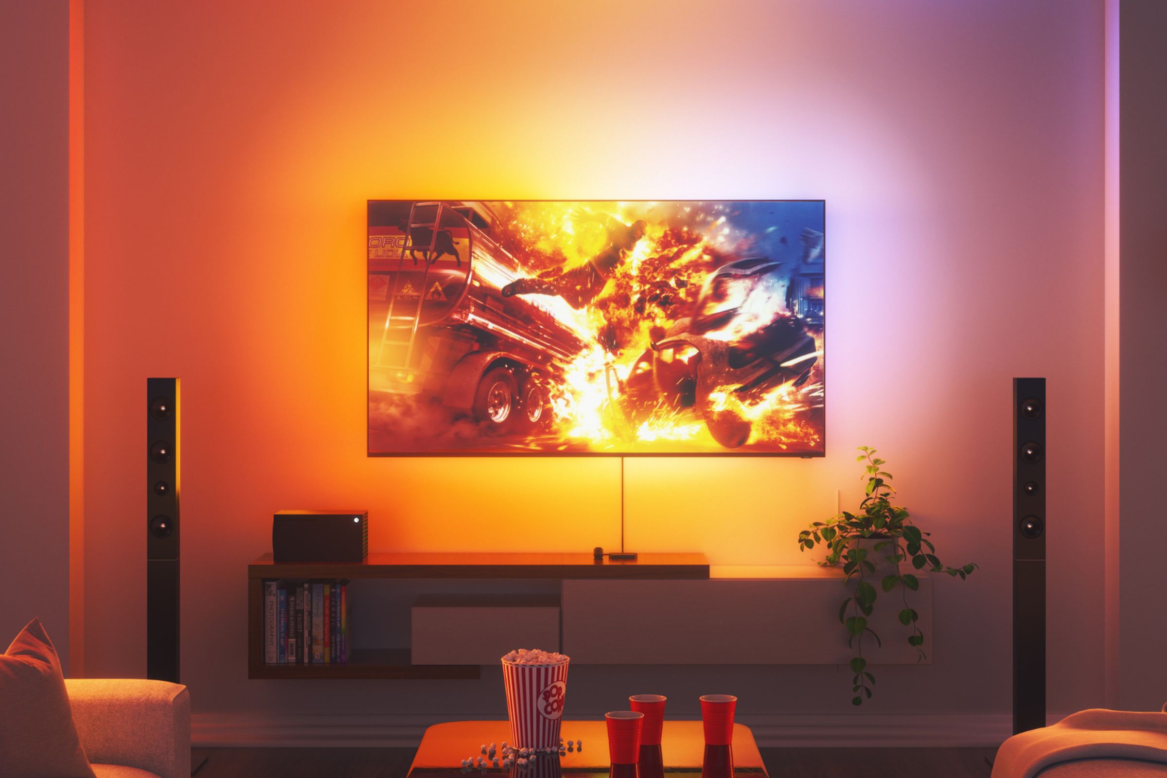 A TV surrounded by colorful light in a modern lounge room.