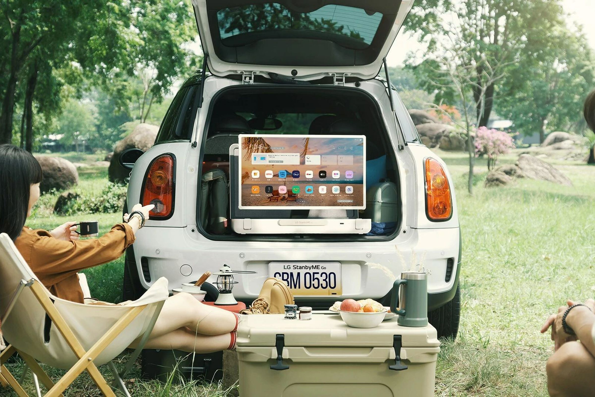 A photo of LG’s StanbyME Go in a picnic setting.