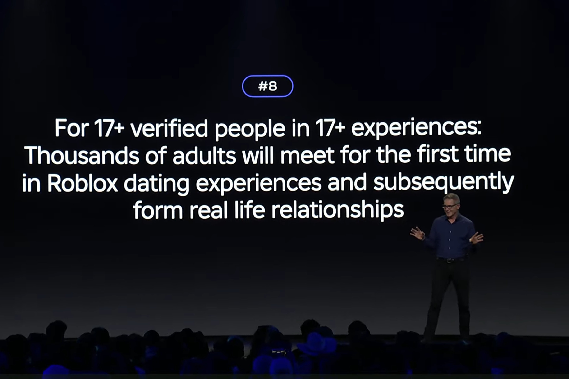Roblox CEO David Baszucki at Roblox Developers Conference (RDC) 2023 in front of a screen showing a prediction about people dating on the platform.