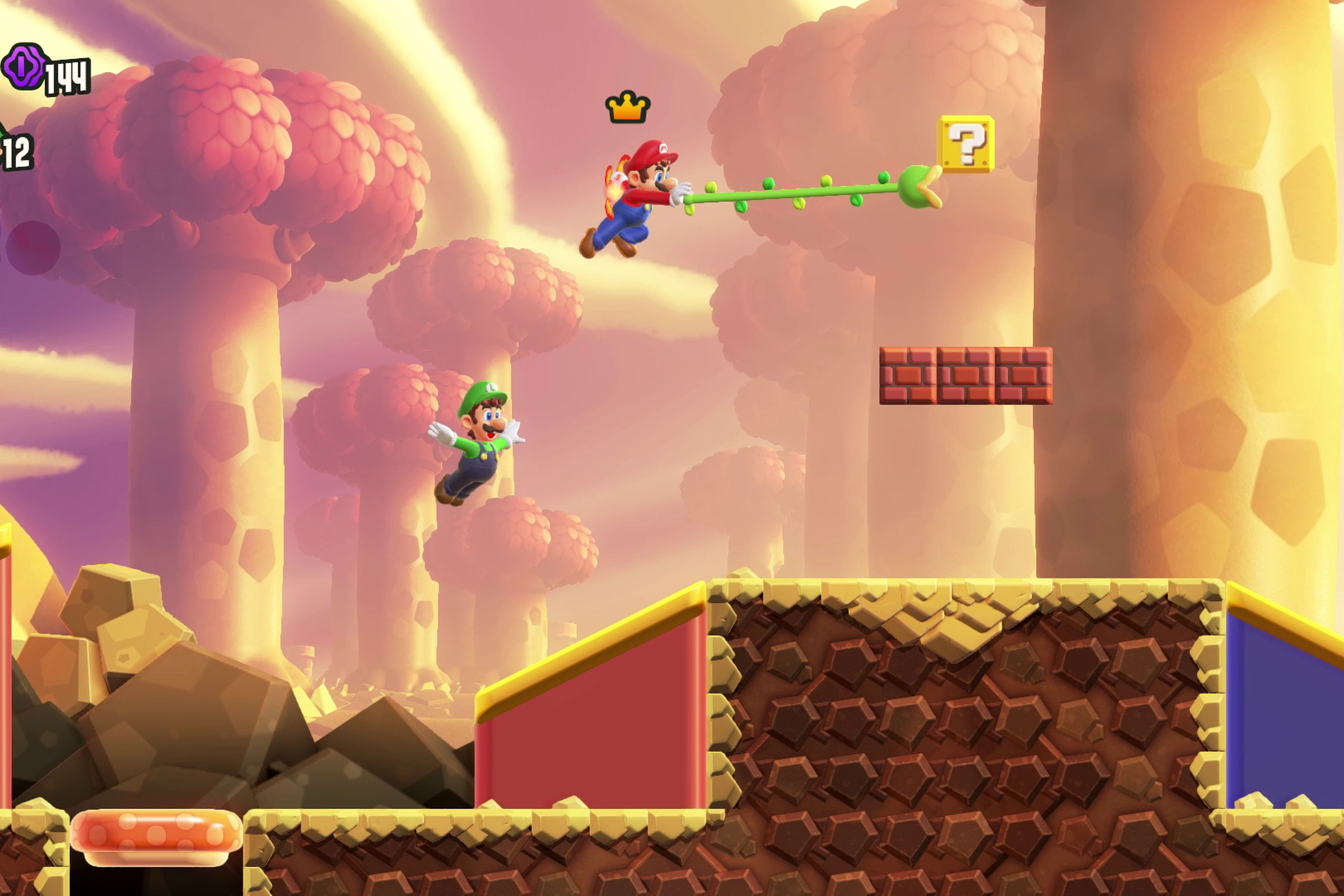 A screenshot from the video game Super Mario Bros. Wonder, in which Mario uses a vine like a grappling hook.