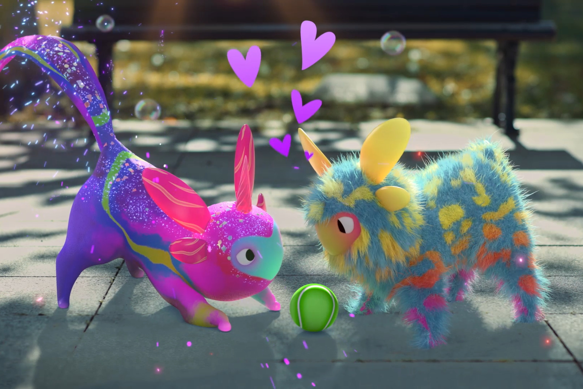 Screenshot from Peridot featuring two “Dots” — colorful alien pet creatures playing with a tennis ball.