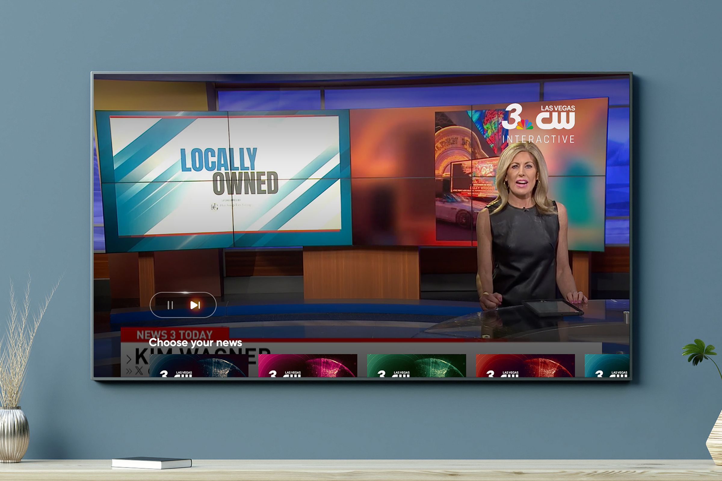 An image of a local news channel, and pause and play button are prominently displayed in the lower-left corner despite this being a broadcast station.