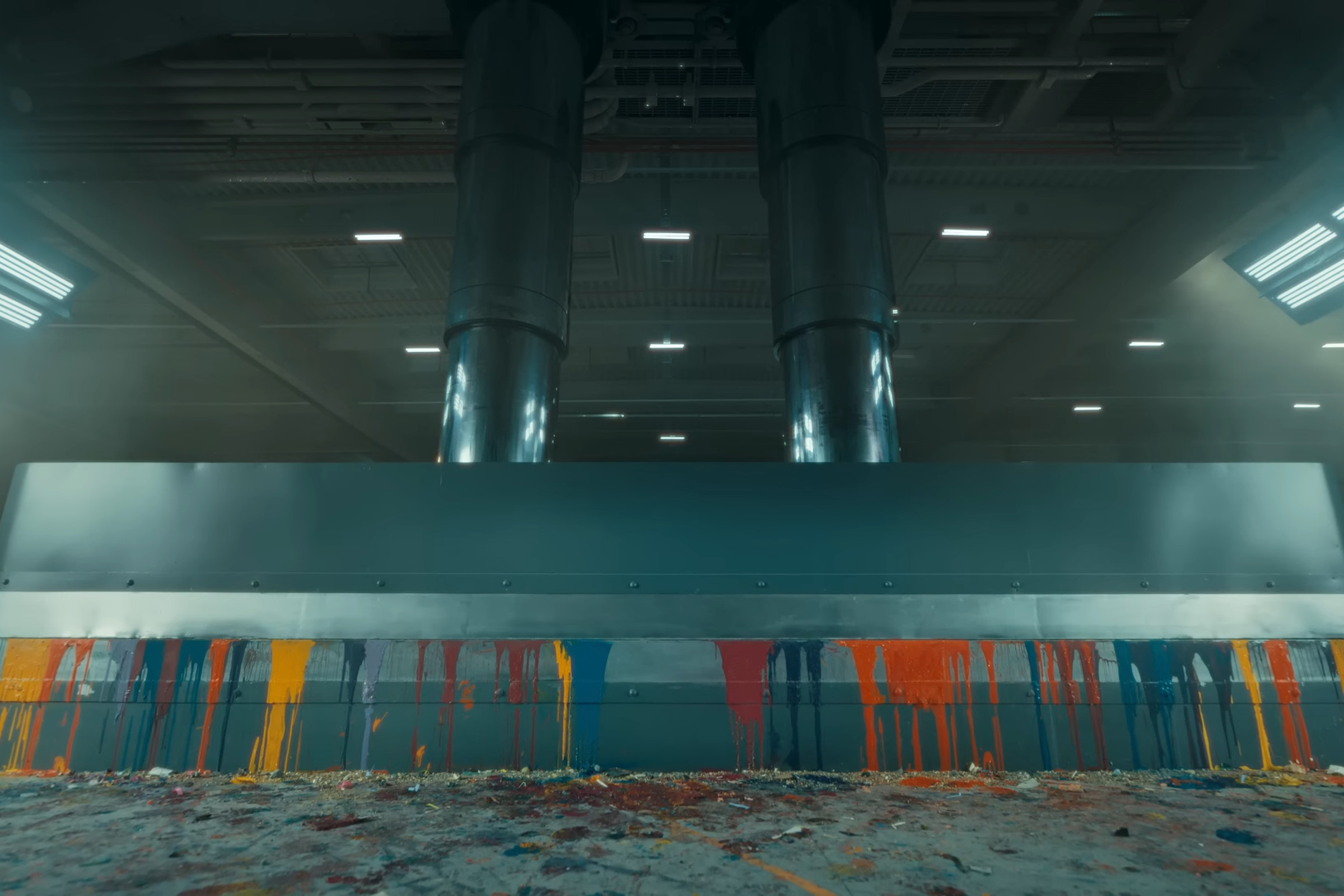 Still image from the “Crush” iPad ad with the press fully closed and only dripping paint and small debris visible outside.