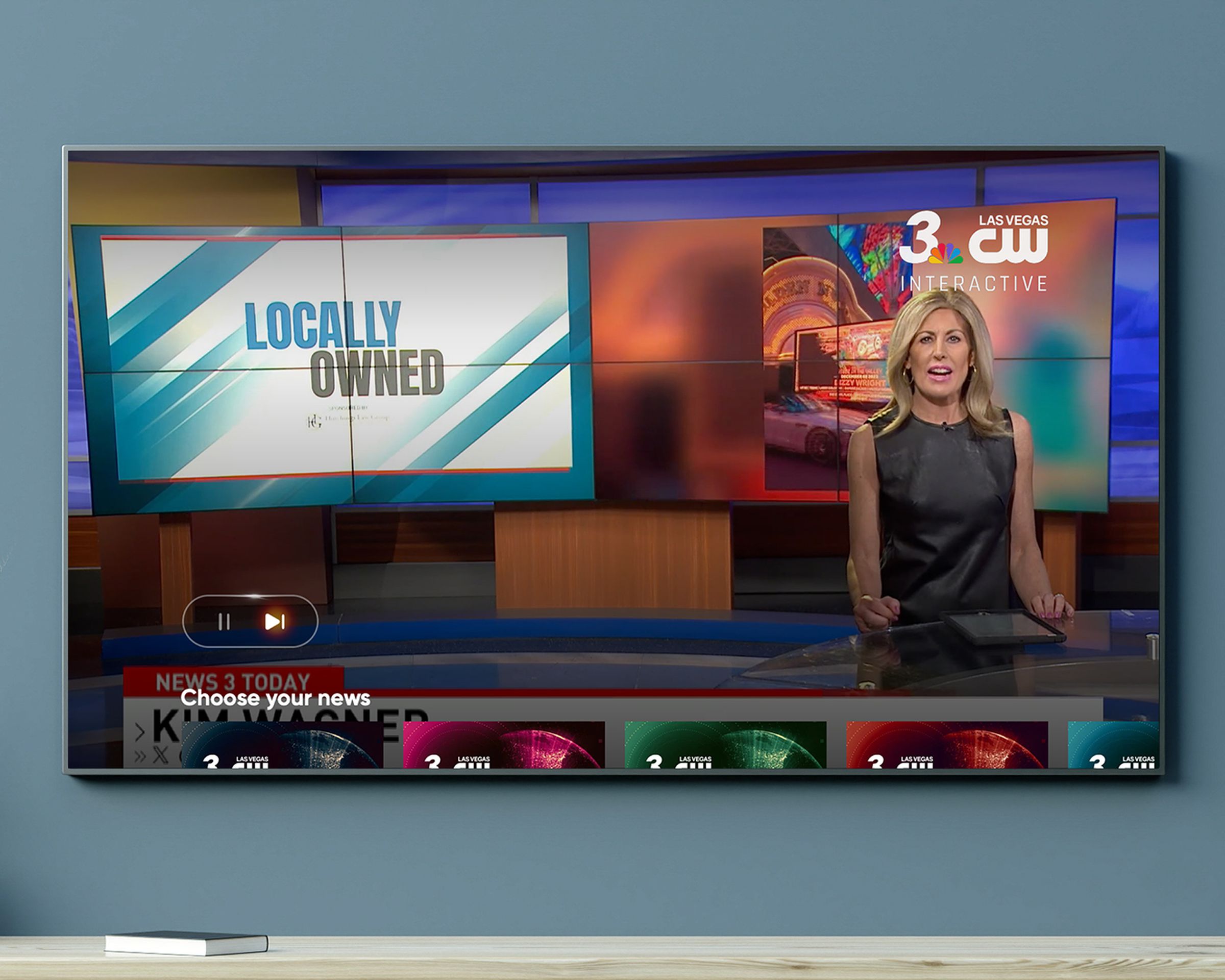 An image of a local news channel, and pause and play button are prominently displayed in the lower-left corner despite this being a broadcast station.