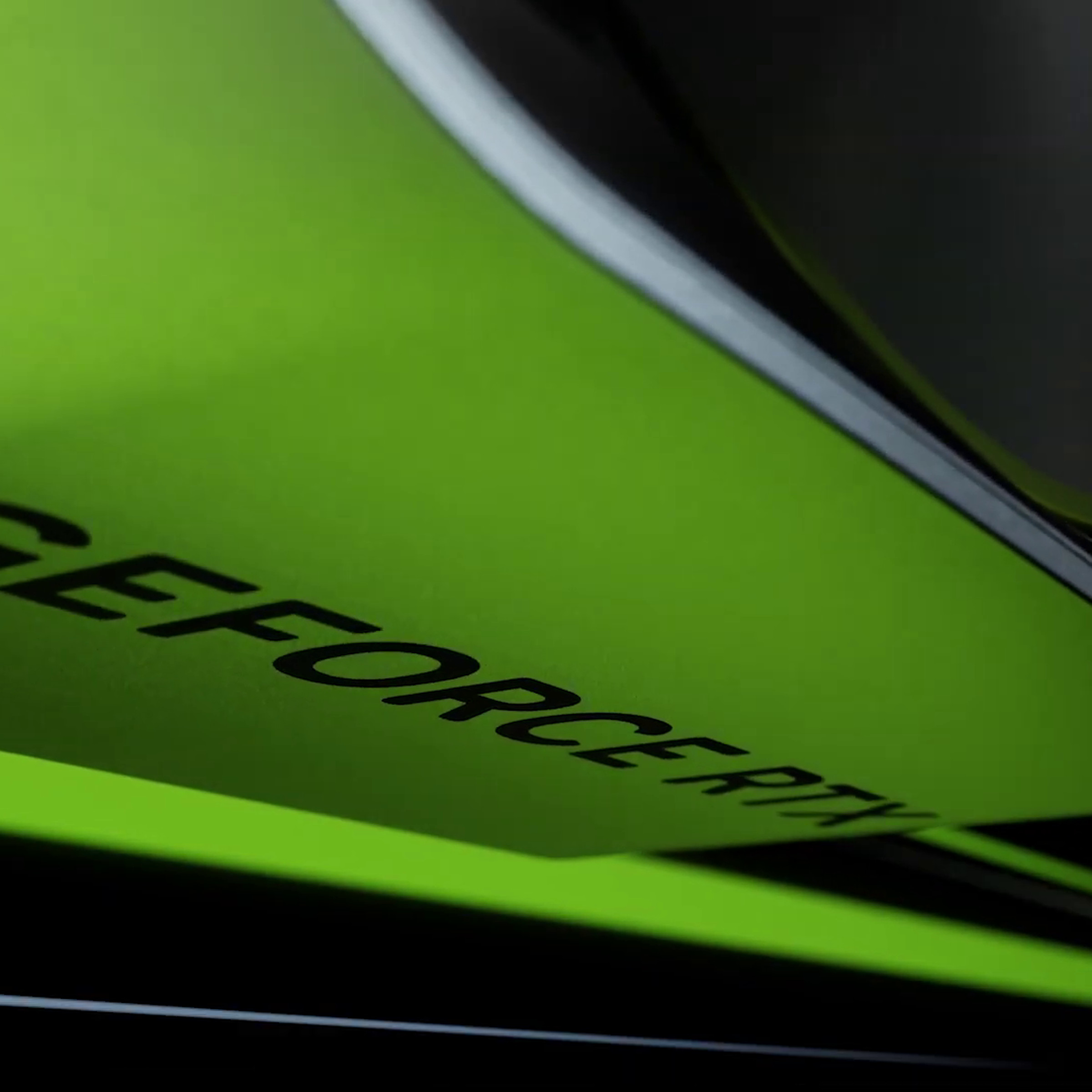 A metal GPU shroud reading GeForce RTX lit up green.