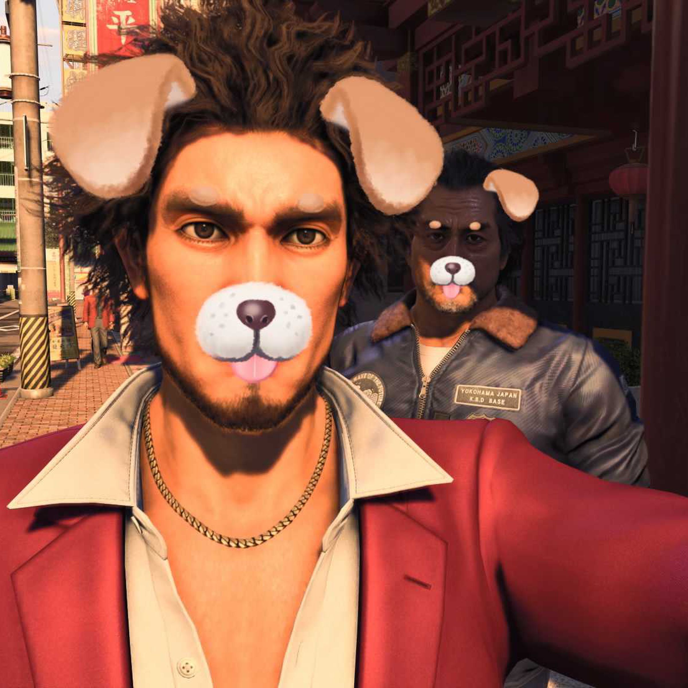 Screenshot from Like a Dragon: Infinite Wealth featuring the game’s protagonist, Ichiban Kasuga, taking a cellphone selfie with a puppy filter