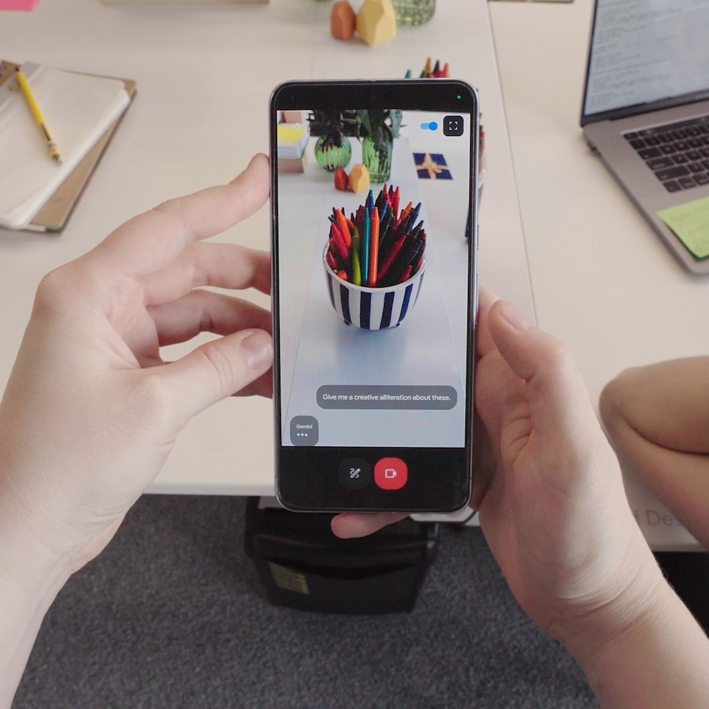 A still from a video showing a phone identifying a bowl of markers.