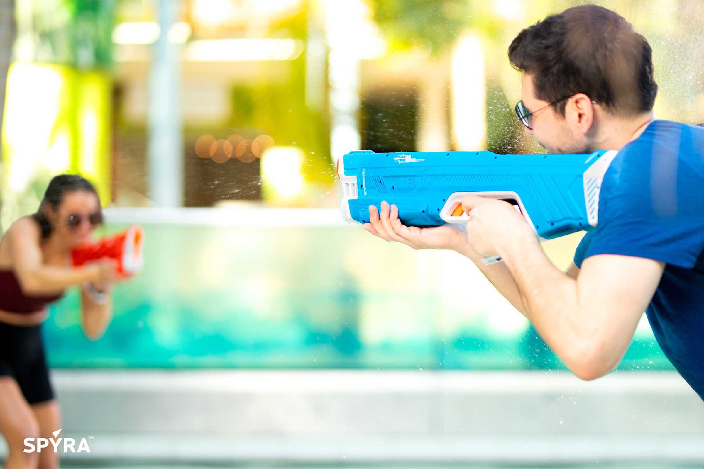Image of two people fighting with water guns.