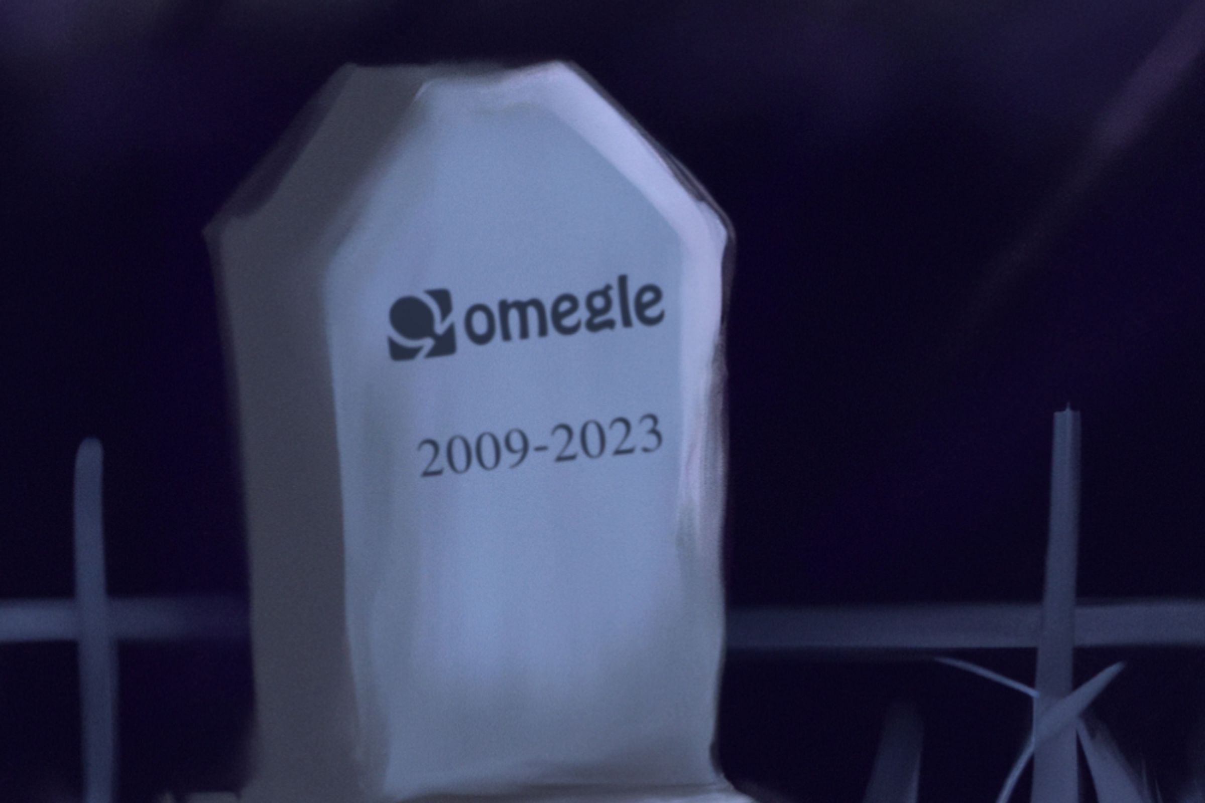 An illustrated gravestone featuring the Omegle logo and a date of 2009 - 2023