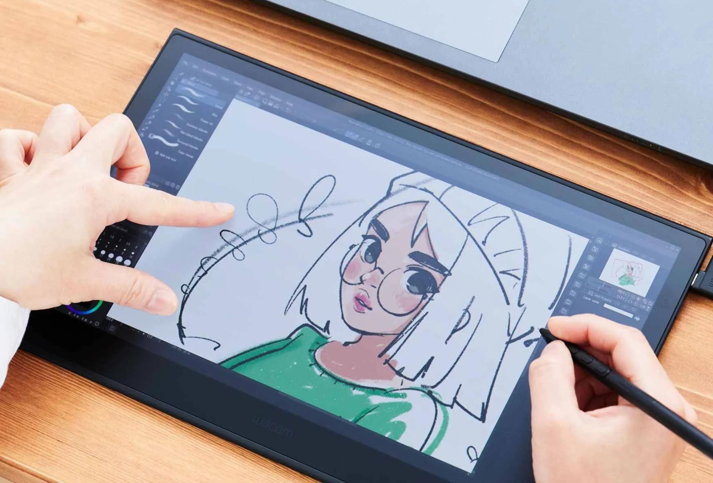The Wacom Movink 13 drawing tablet being used with fingers.