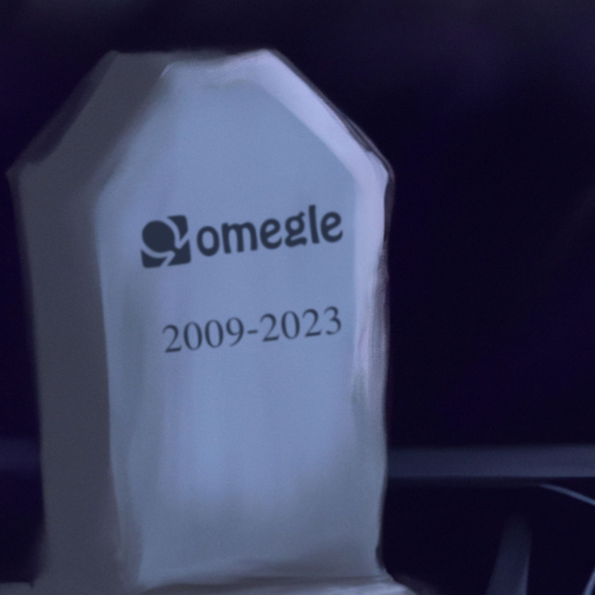 An illustrated gravestone featuring the Omegle logo and a date of 2009 - 2023