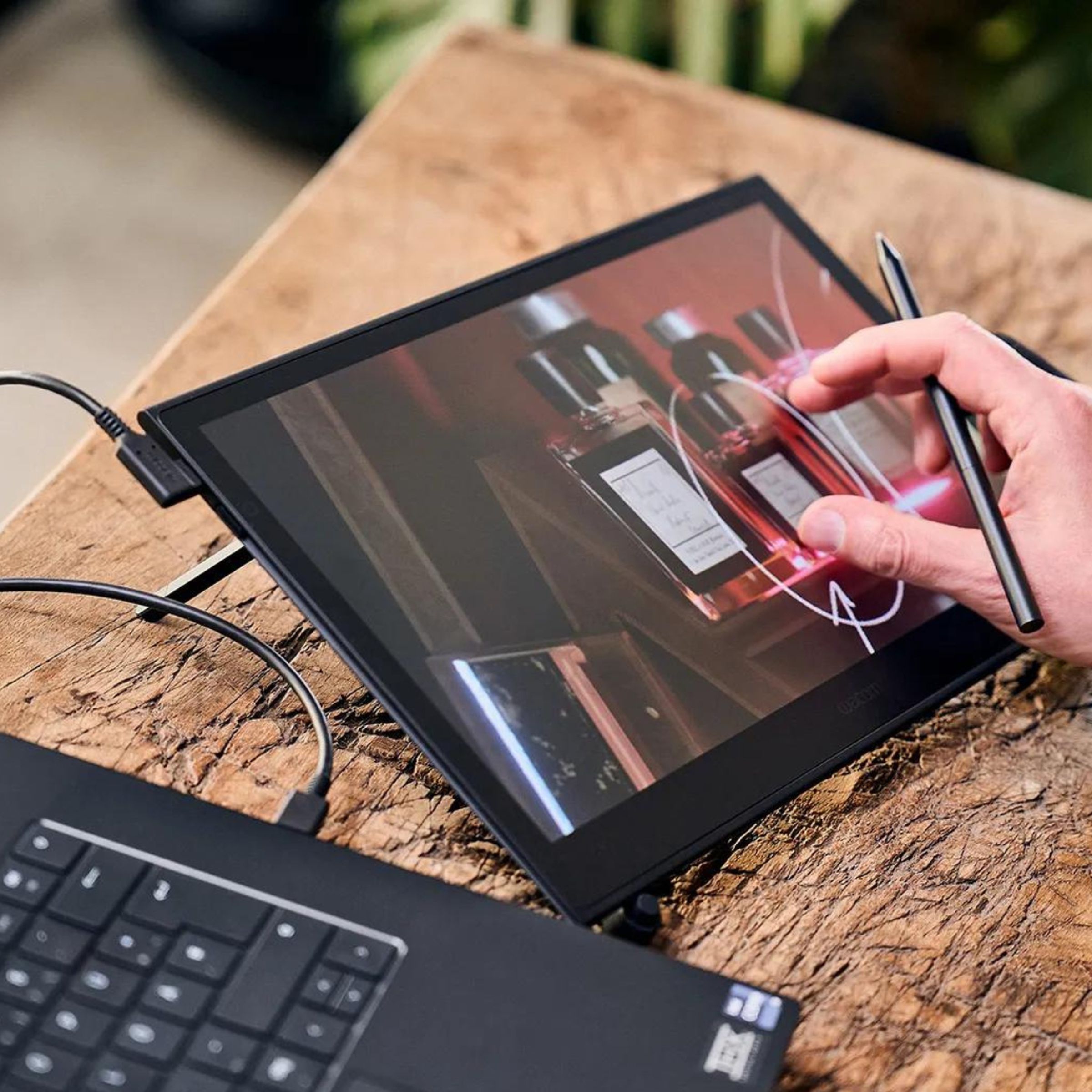 Someone using the Wacom Movink 13 display drawing tablet with a connected laptop.