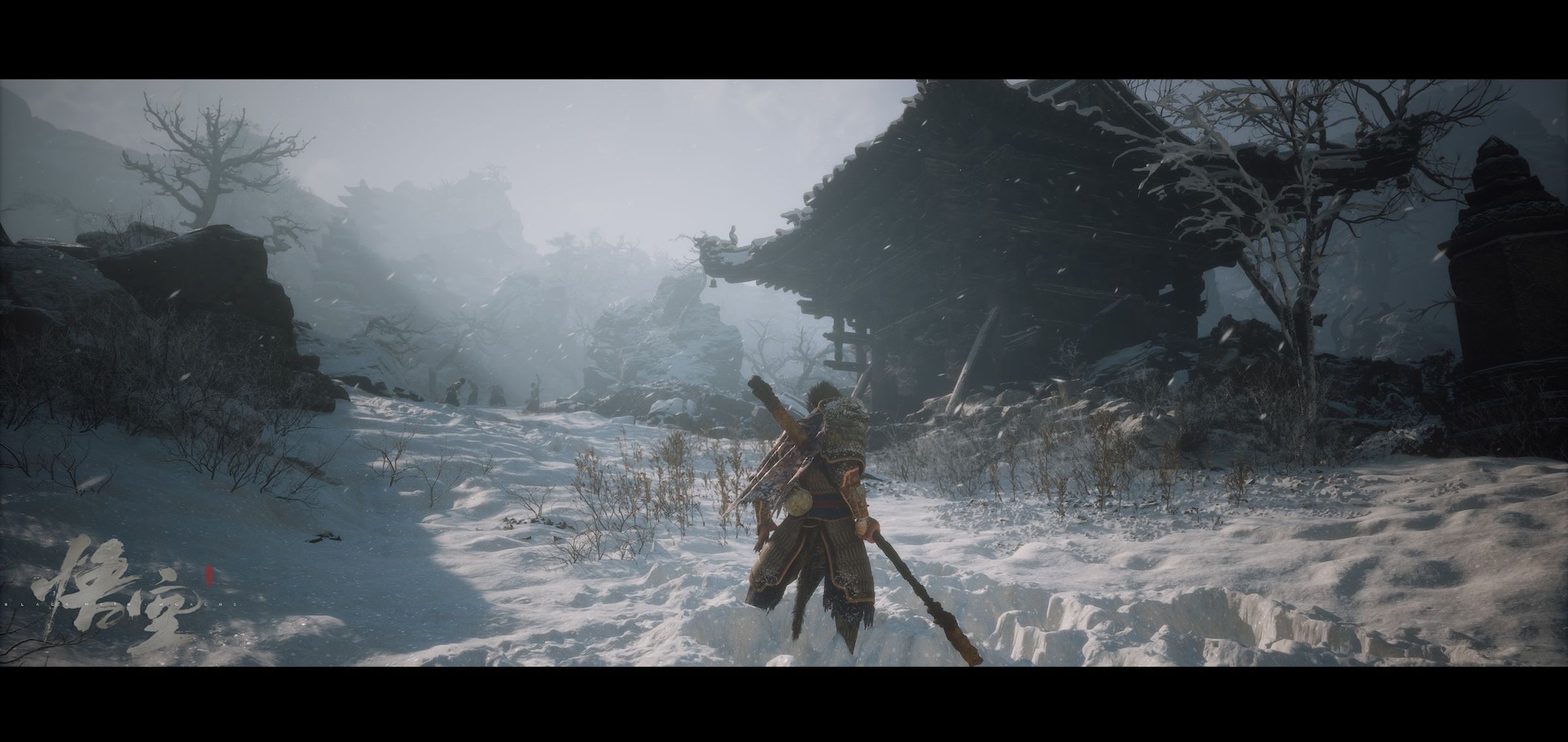 Screenshot from Black Myth: Wukong featuring the main character a humanoid monkey person standing in deep snow looking at a derelict temple.