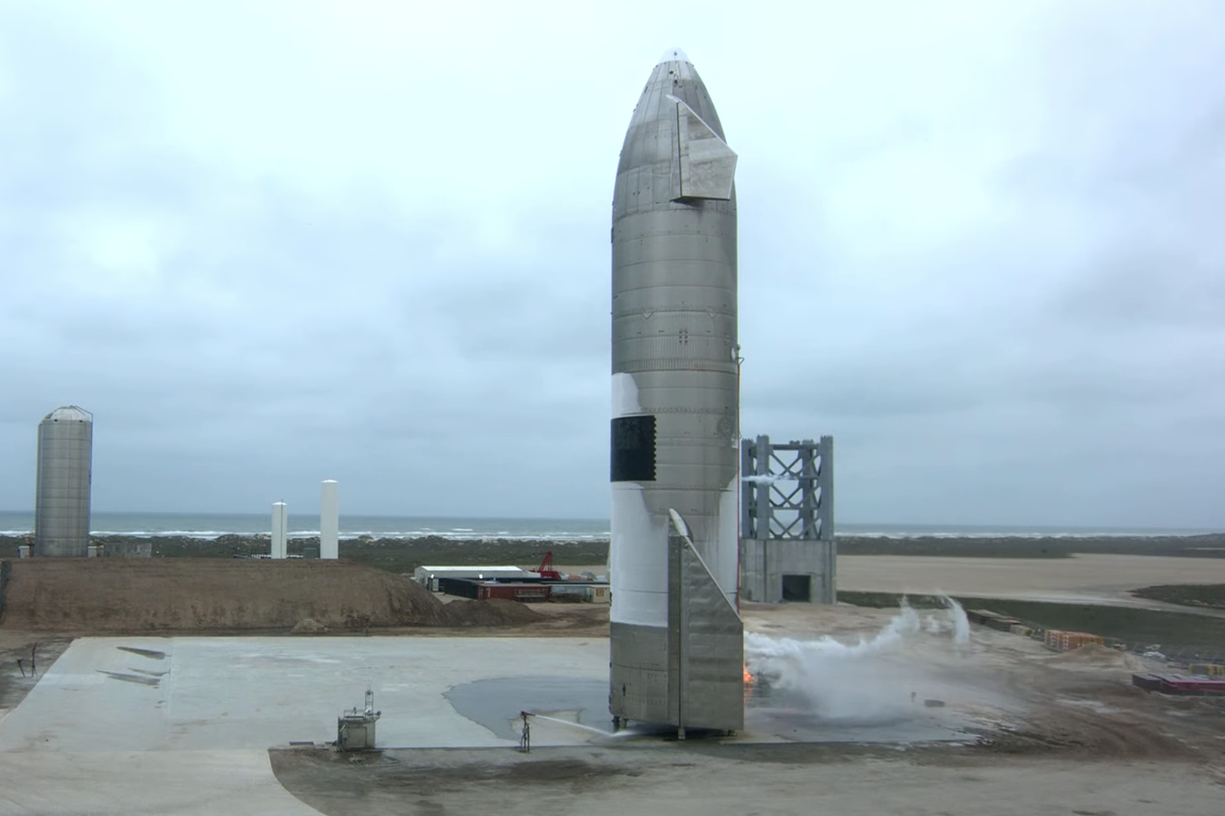 A rocket sitting on a concrete pad