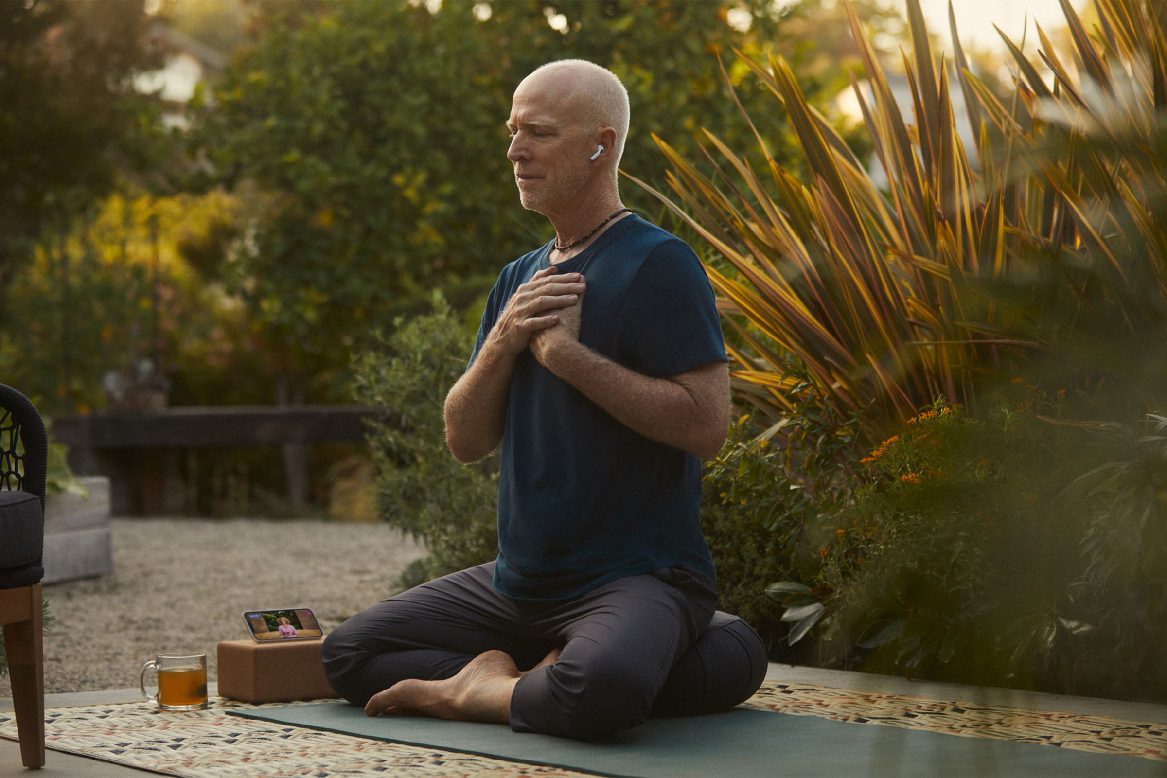 Apple Fitness Plus trainer Gregg Cook meditating.