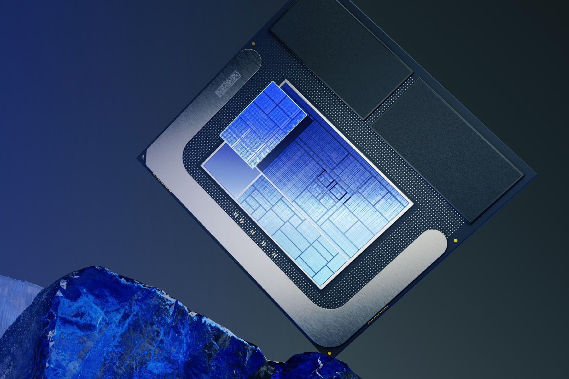 A bare piece of blue shiny processor stands balanced on one corner