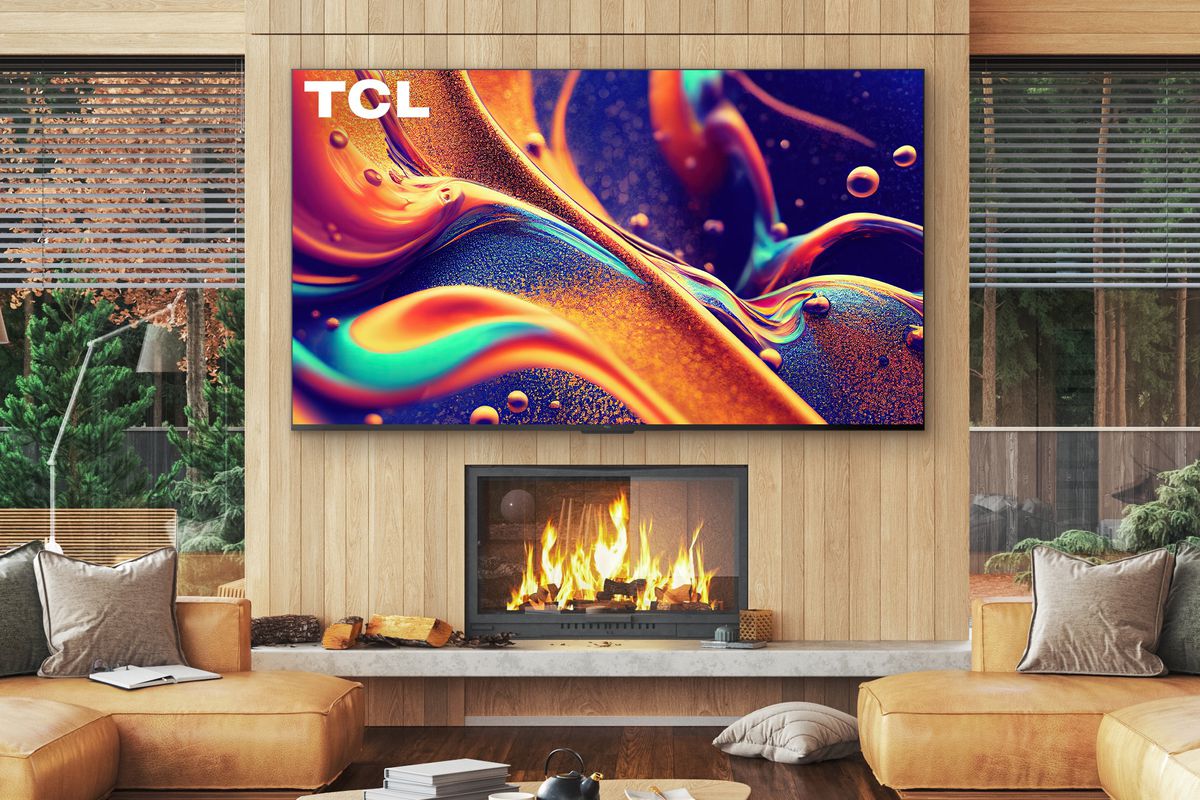 A huge 98-inch TCL television hung above a fireplace. 