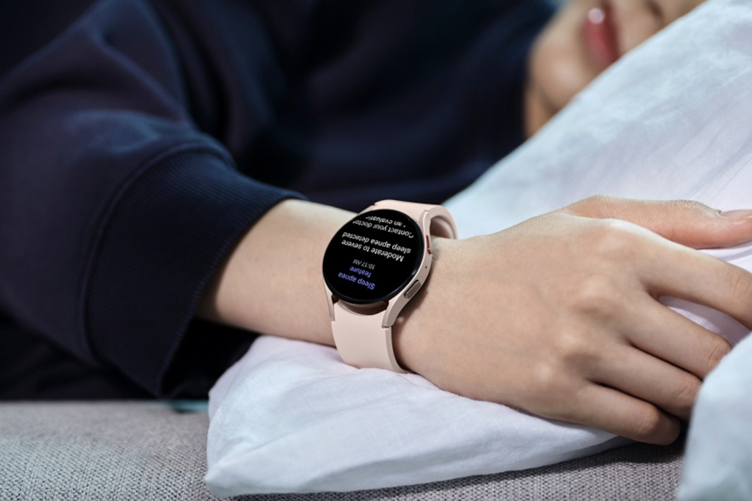 A person wearing the Samsung Galaxy Watch as they sleep.