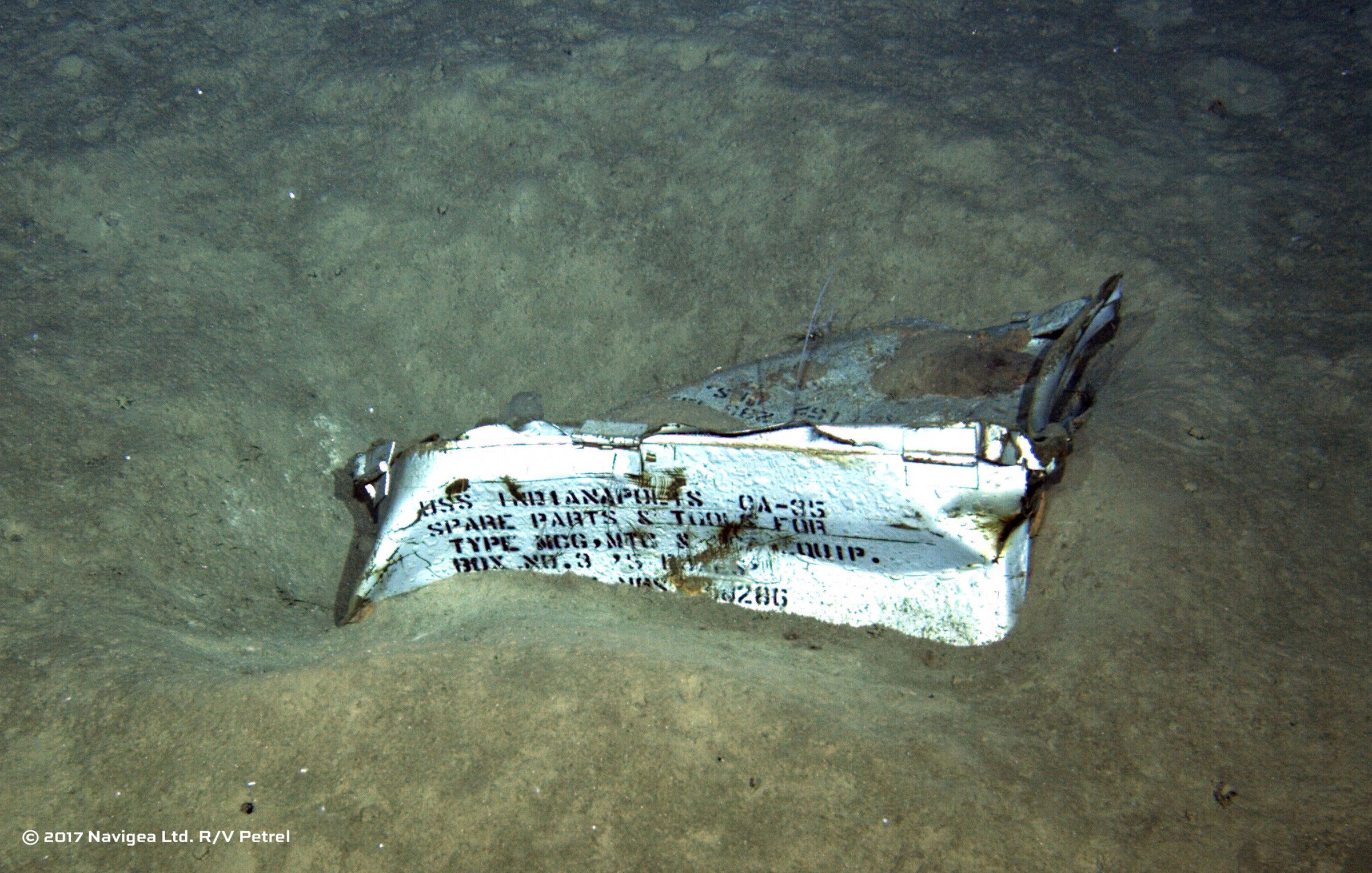 An image shot from a remotely operated underwater vehicle shows a spare parts box from USS Indianapolis on the floor of the Pacific Ocean in more than 16,000 feet of water. 
