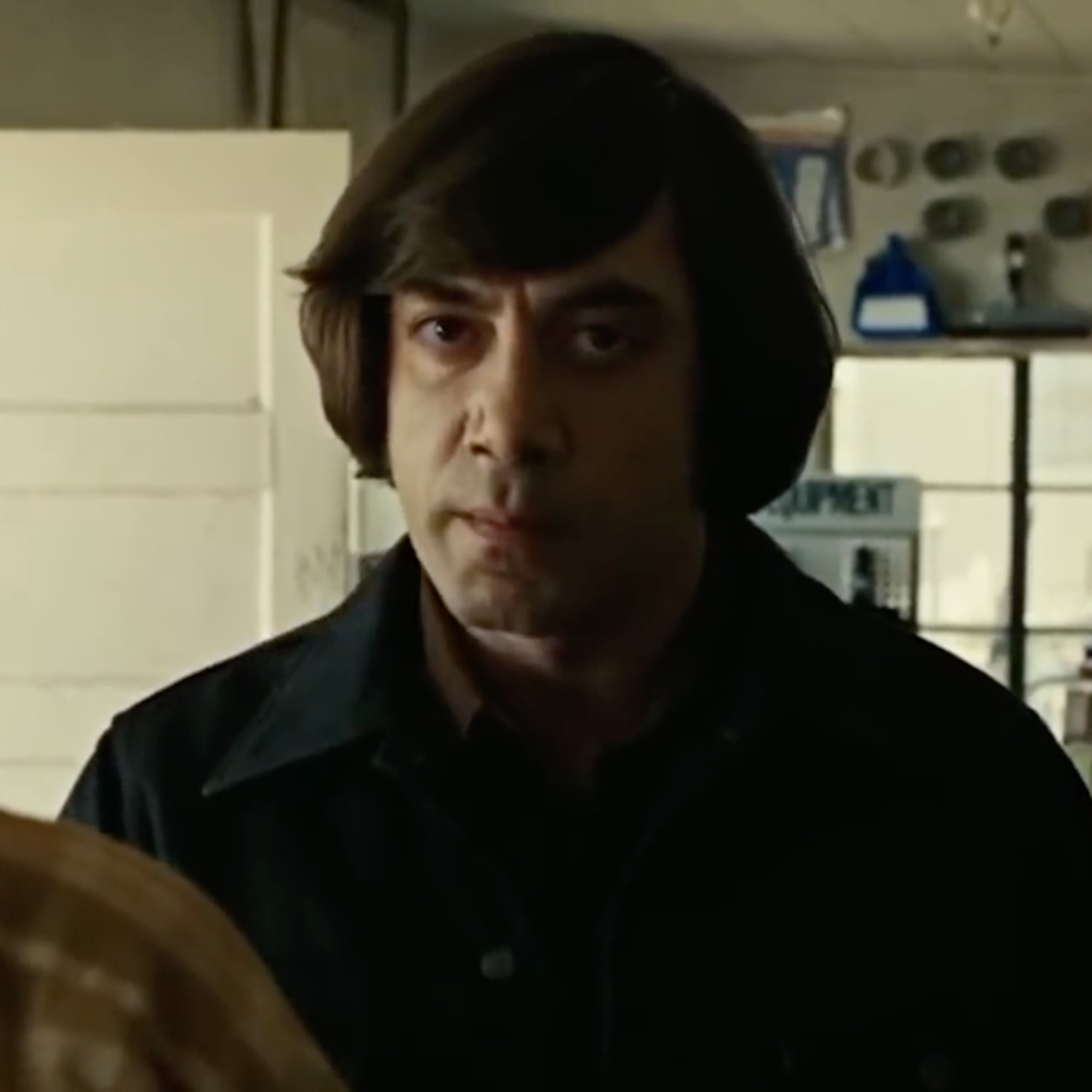 A GIF of the character of Anton Chigurh from No Country for Old Men staring directly at the camera thanks to the adjustment by AI.