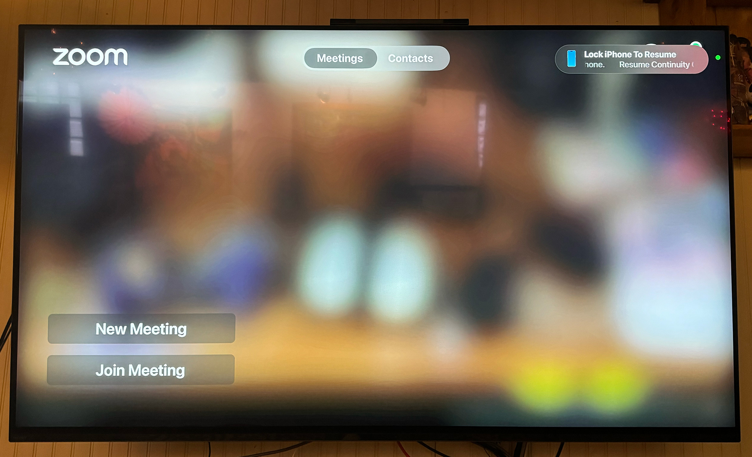 A picture of the Zoom meeting intro screen on a TV.