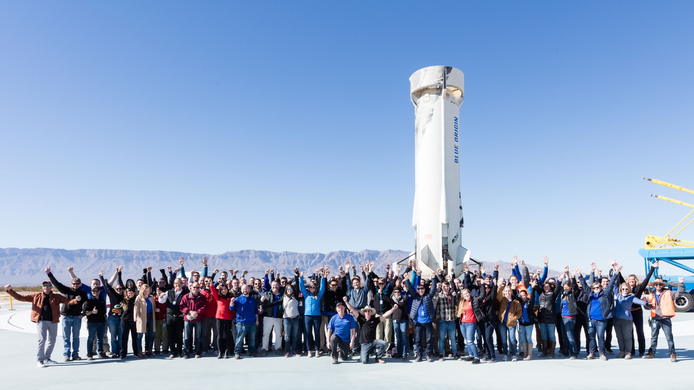 Blue Origin employees celebrating a successful launch and landing of New Shepard in West Texas.