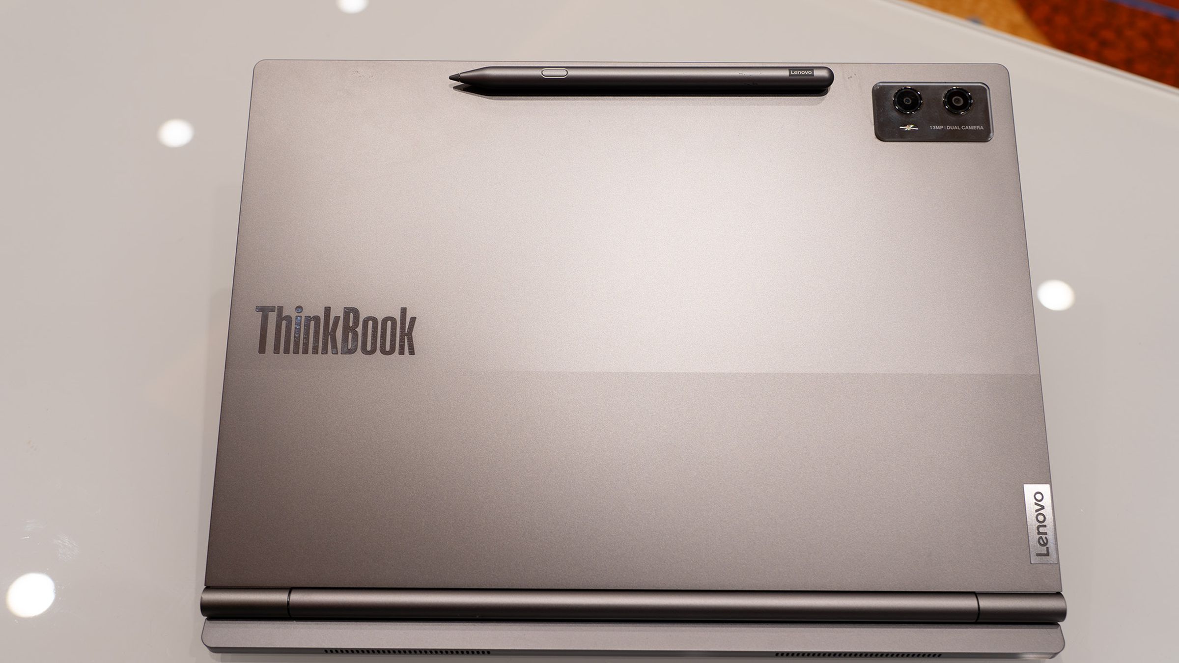 An image of a laptop with a stylus attached to the lid magnetically.