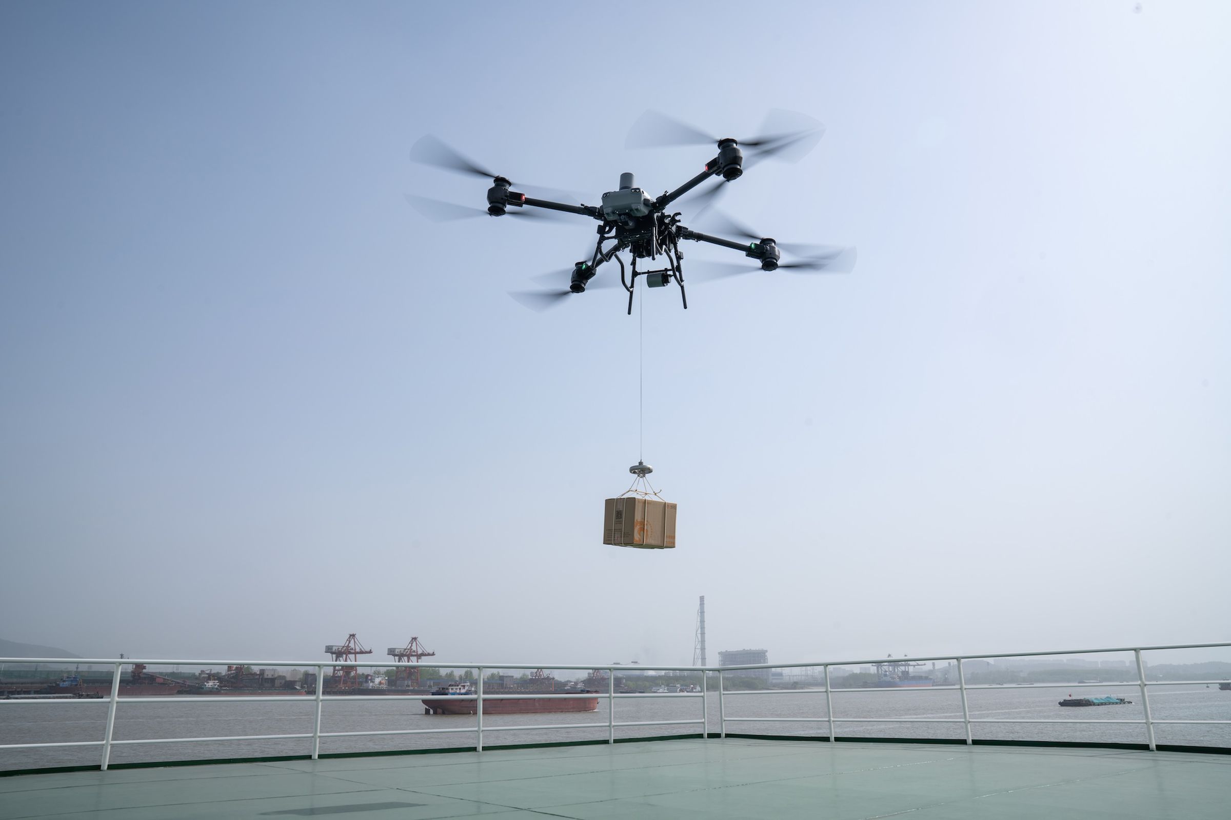 A photo of DJI’s FlyCart 30 drone in the air.