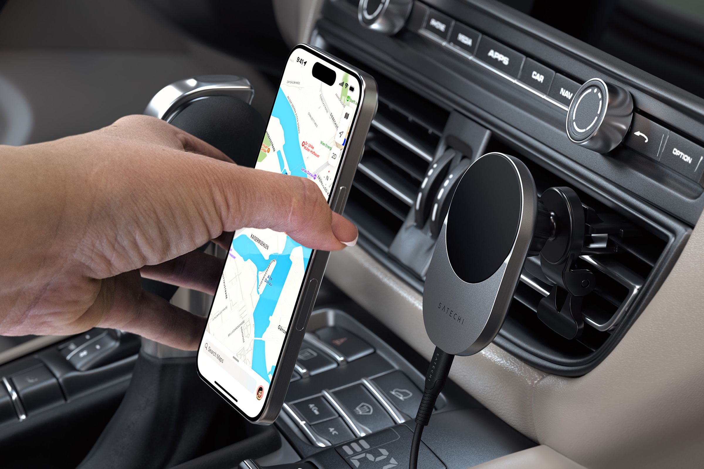 A user attaching a smartphone to the Satechi Qi2 Wireless Car Charger.