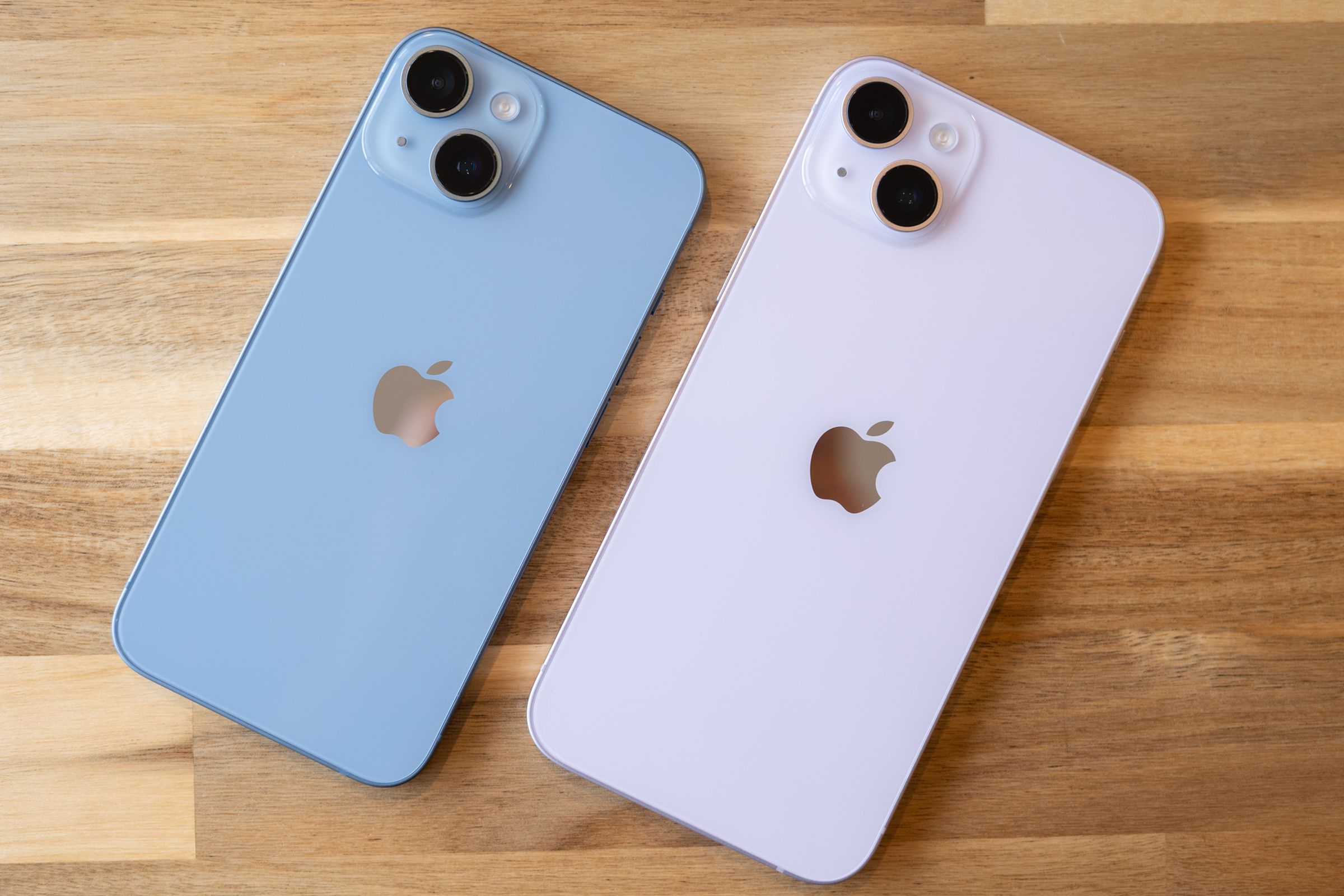 iPhone 14 in blue next to iPhone 14 Plus in purple