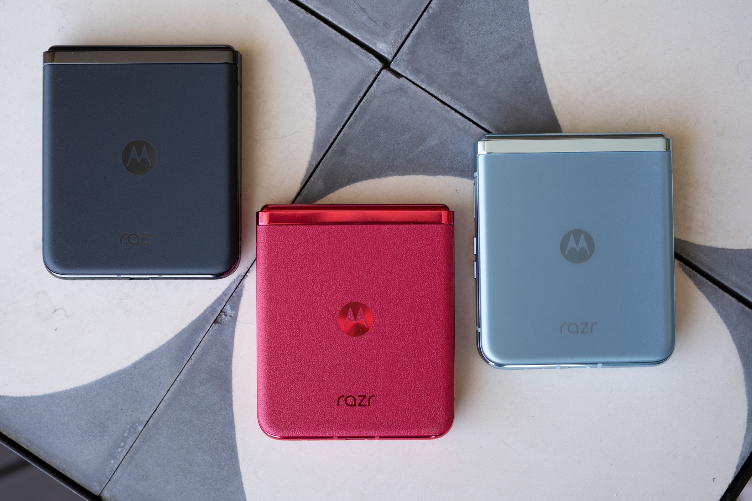 Top-down shot of Motorola Razr Plus in magenta, blue, and black.
