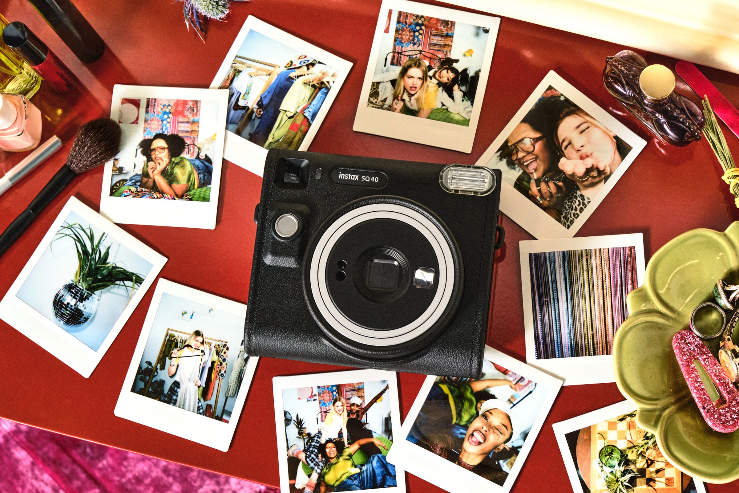 Fujifilm Instax Square SQ40 instant camera surrounded by photos it printed of people.