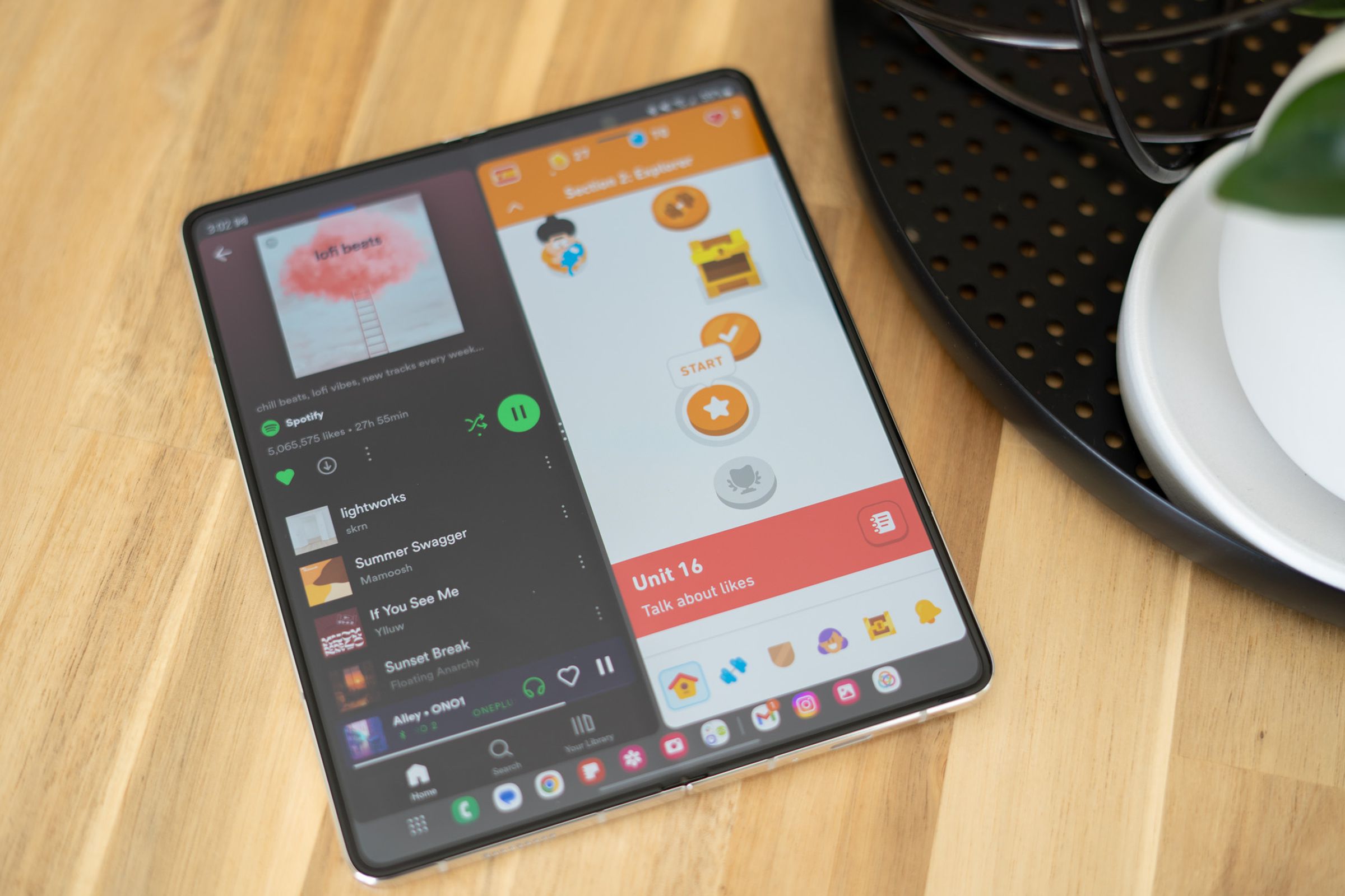 Samsung Galaxy Z Fold 5 unfolded on a table showing two apps running side by side.
