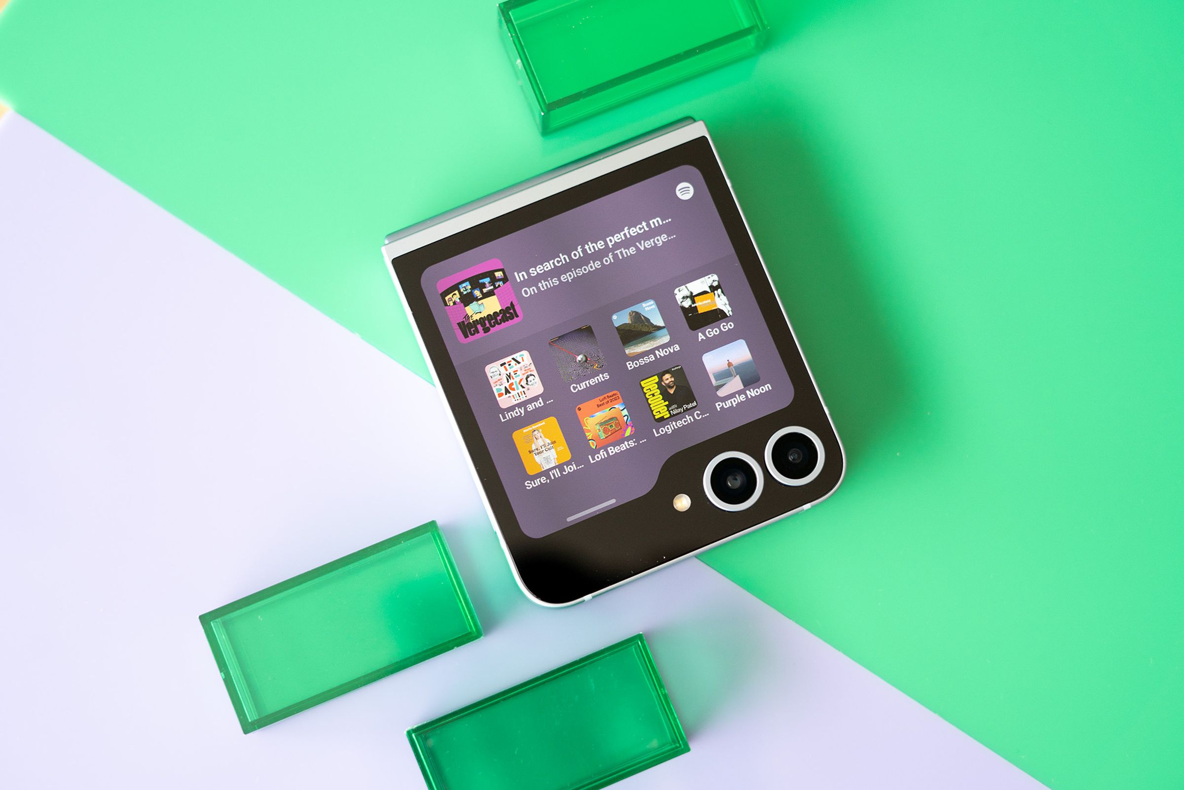 Samsung Galaxy Z Flip 6 on a purple and green background.