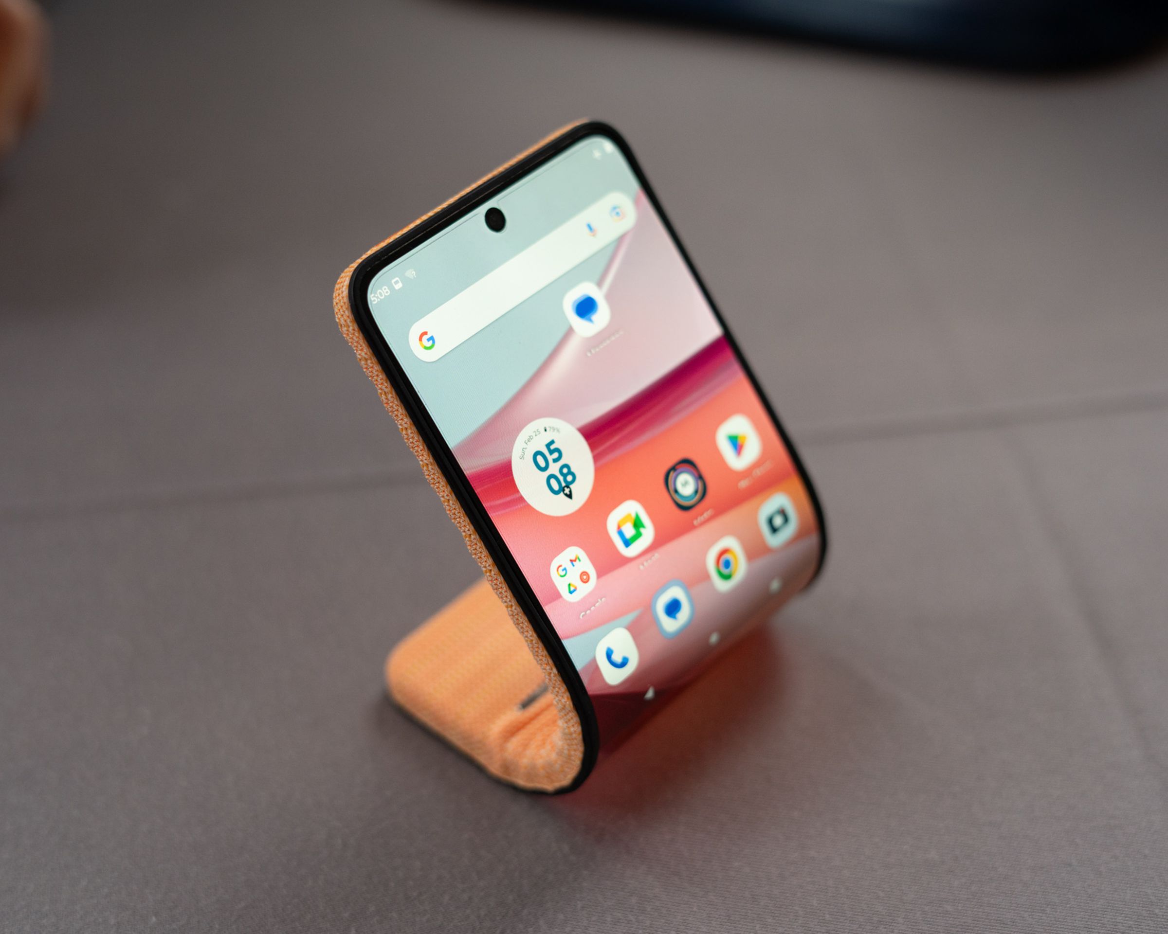 Motorola’s bending phone concept, curved and sitting on a table.