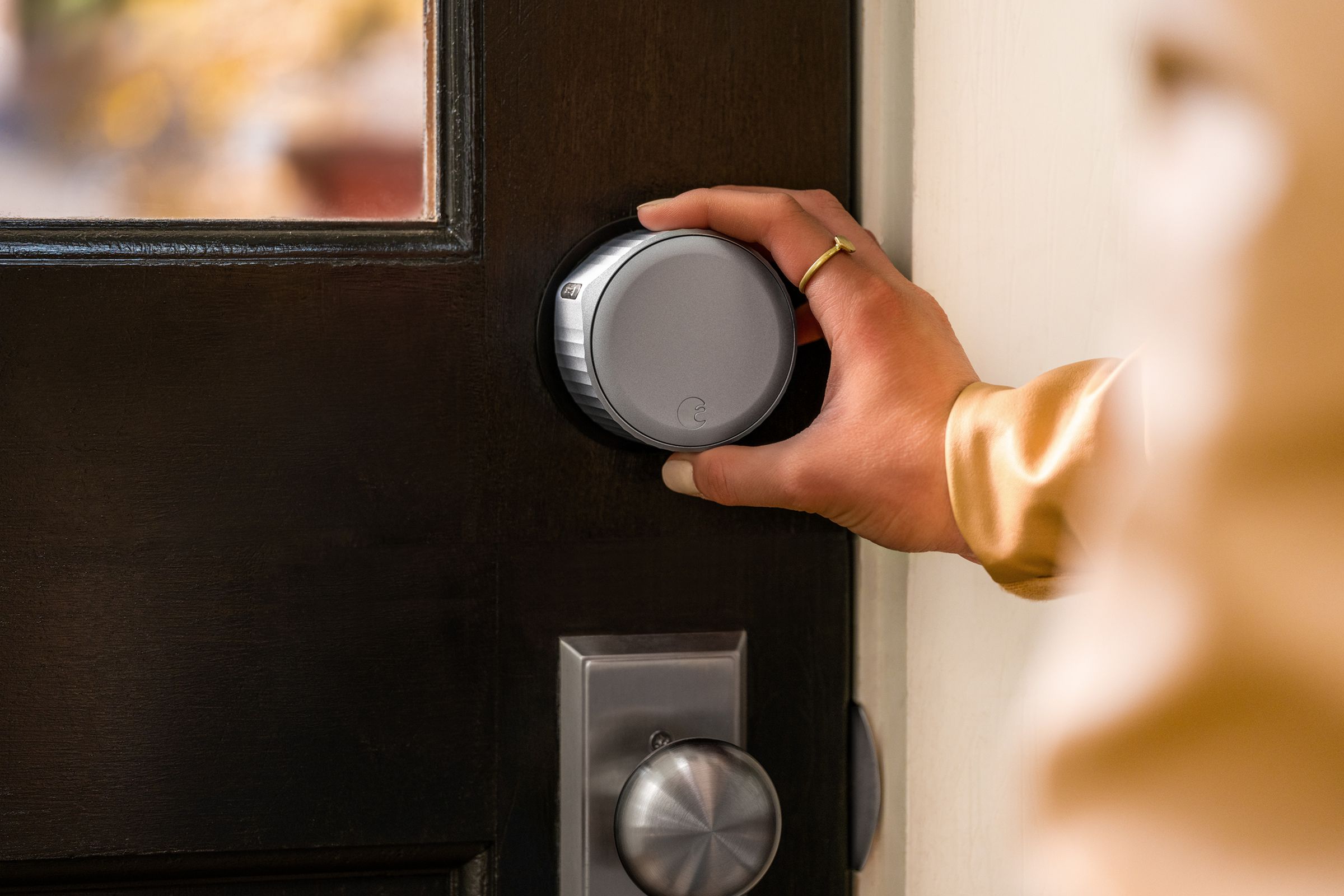 An August Wi-Fi Smart Lock being used to lock the door.