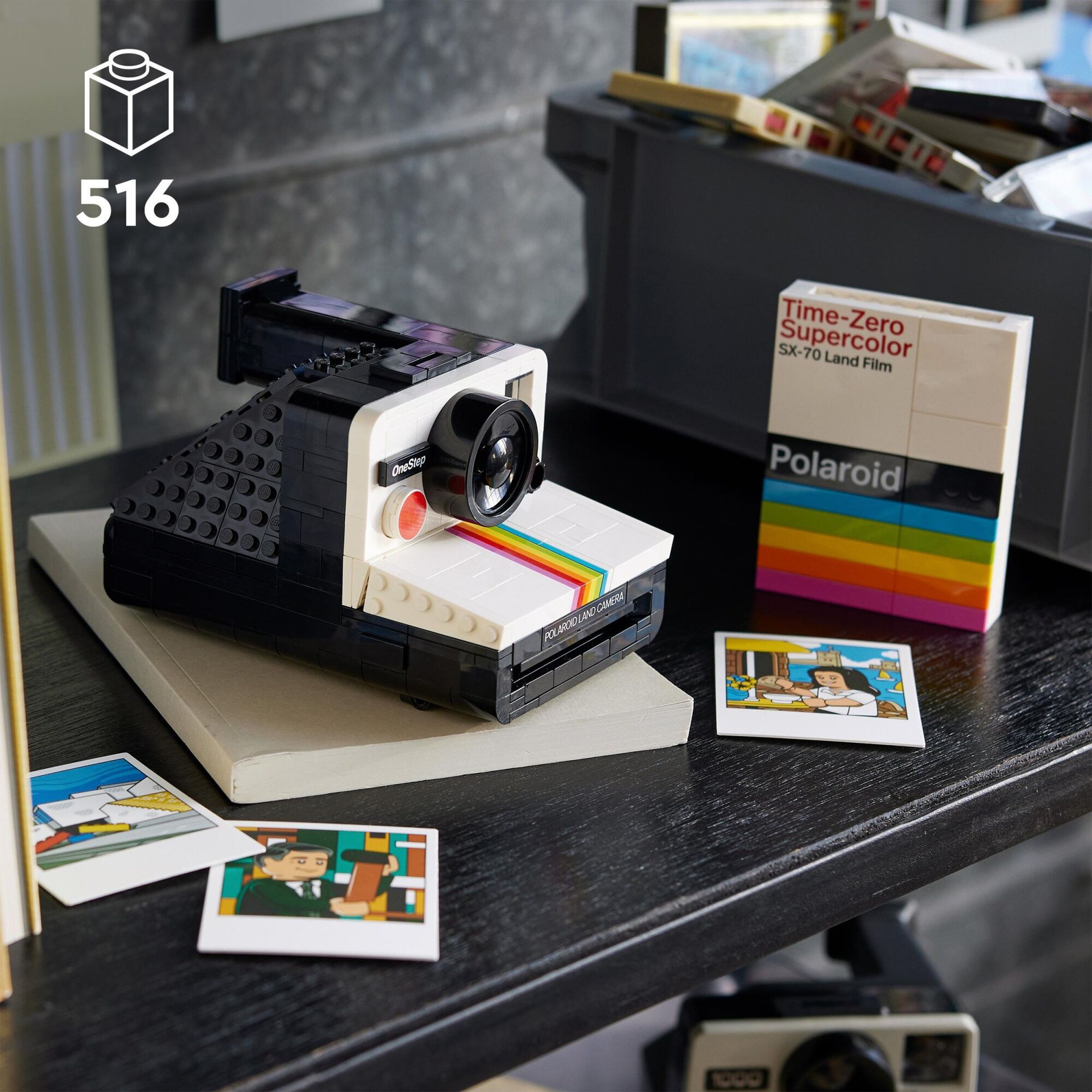 A picture of the Lego Polaroid camera on a table with photos next to it.